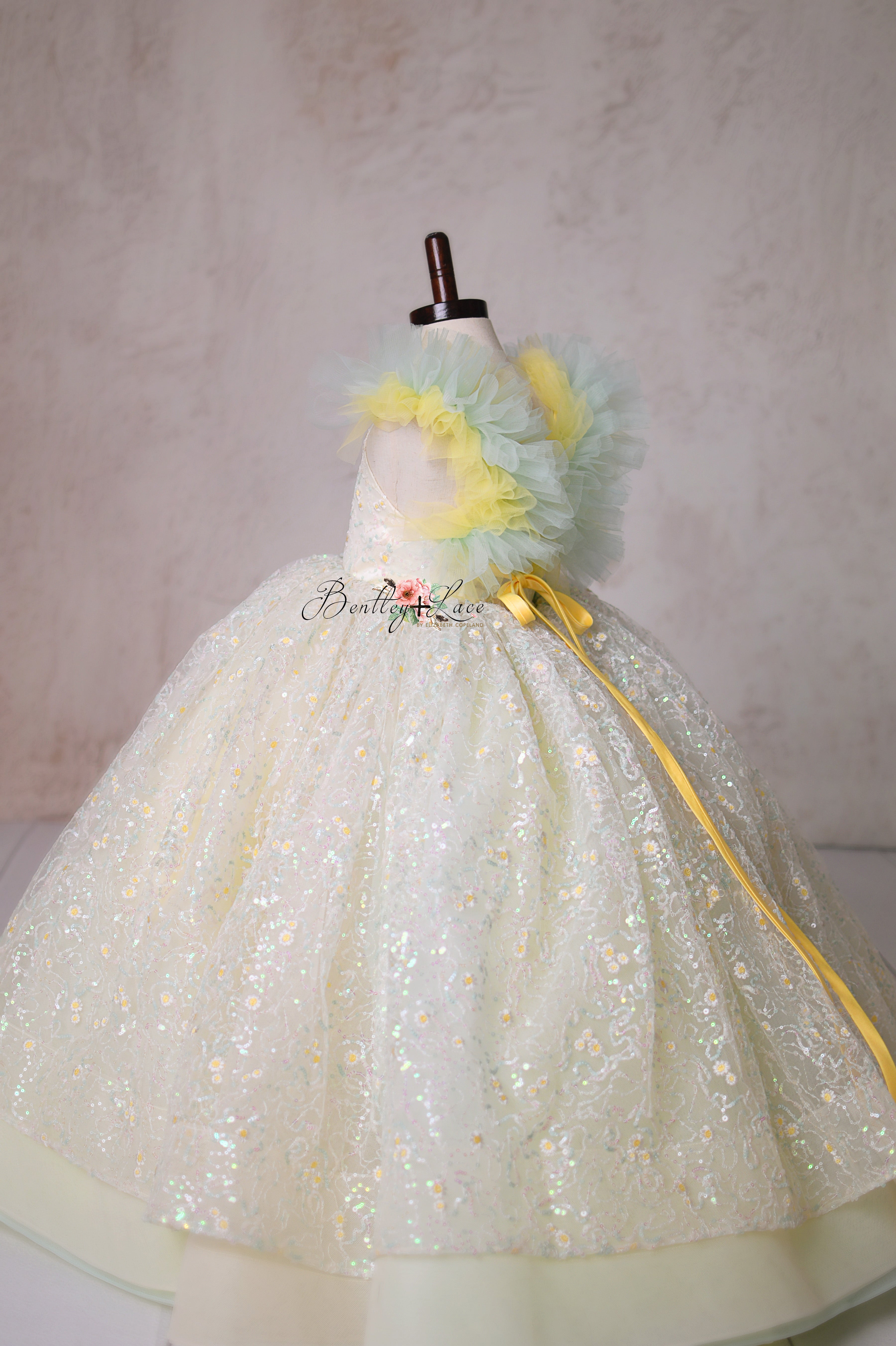 Let your little one shine in the Harmony Gown, a couture masterpiece with delicate lace, ethereal pastels, and a dreamy full skirt.
