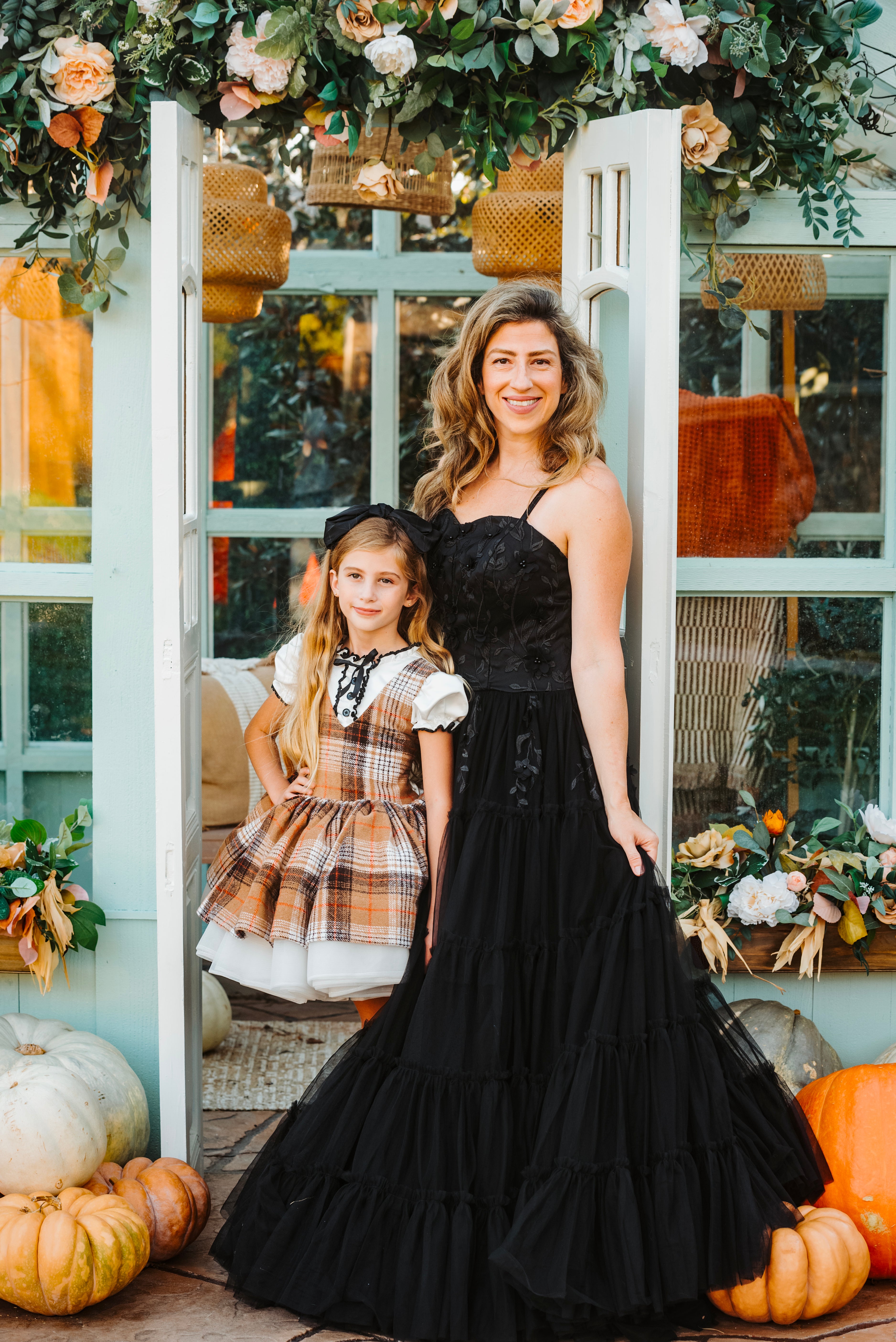 Family dressed in coordinated outfits, featuring a beautiful gown for the mother.