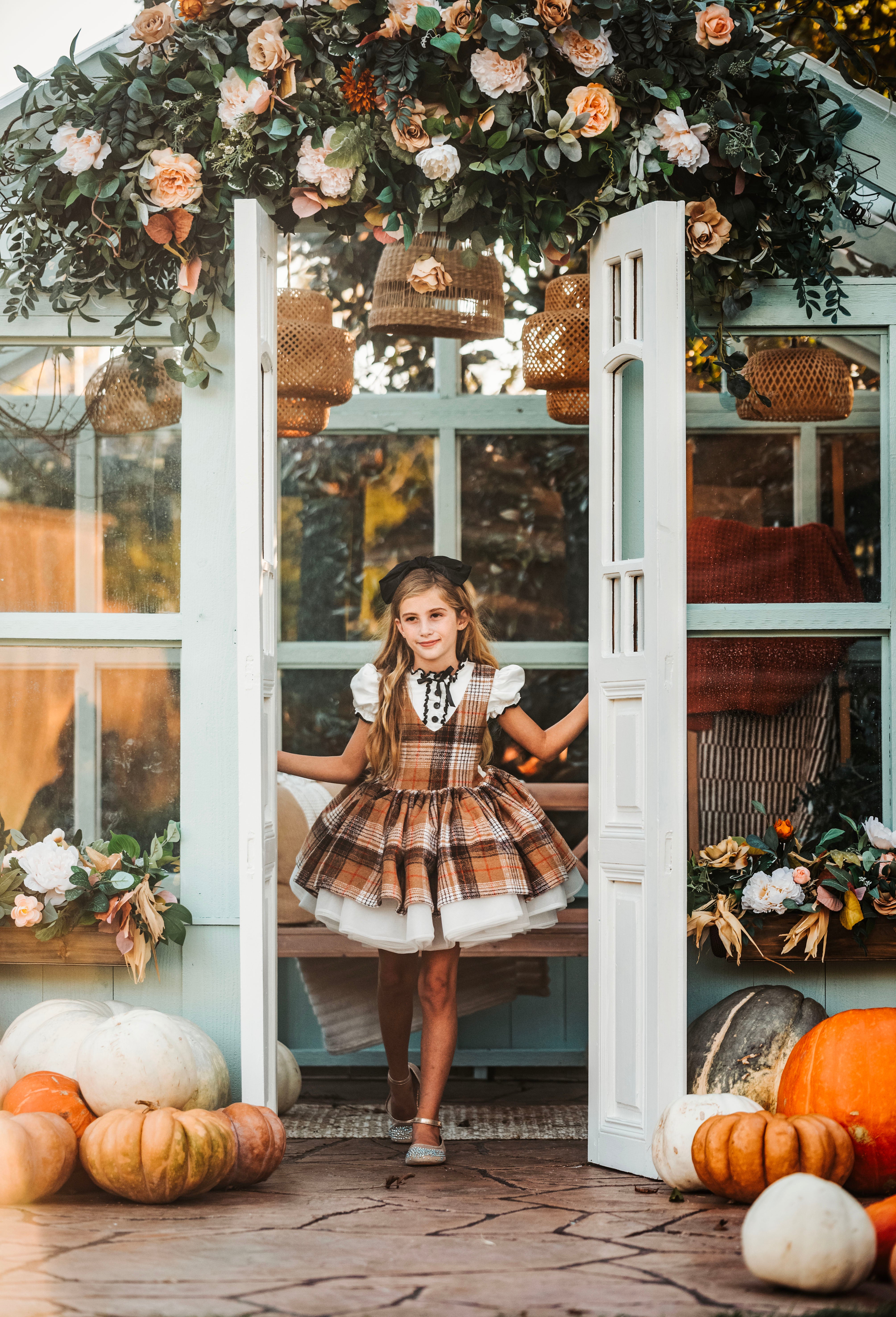 Child twirling in a whimsical gown during a themed photoshoot.
