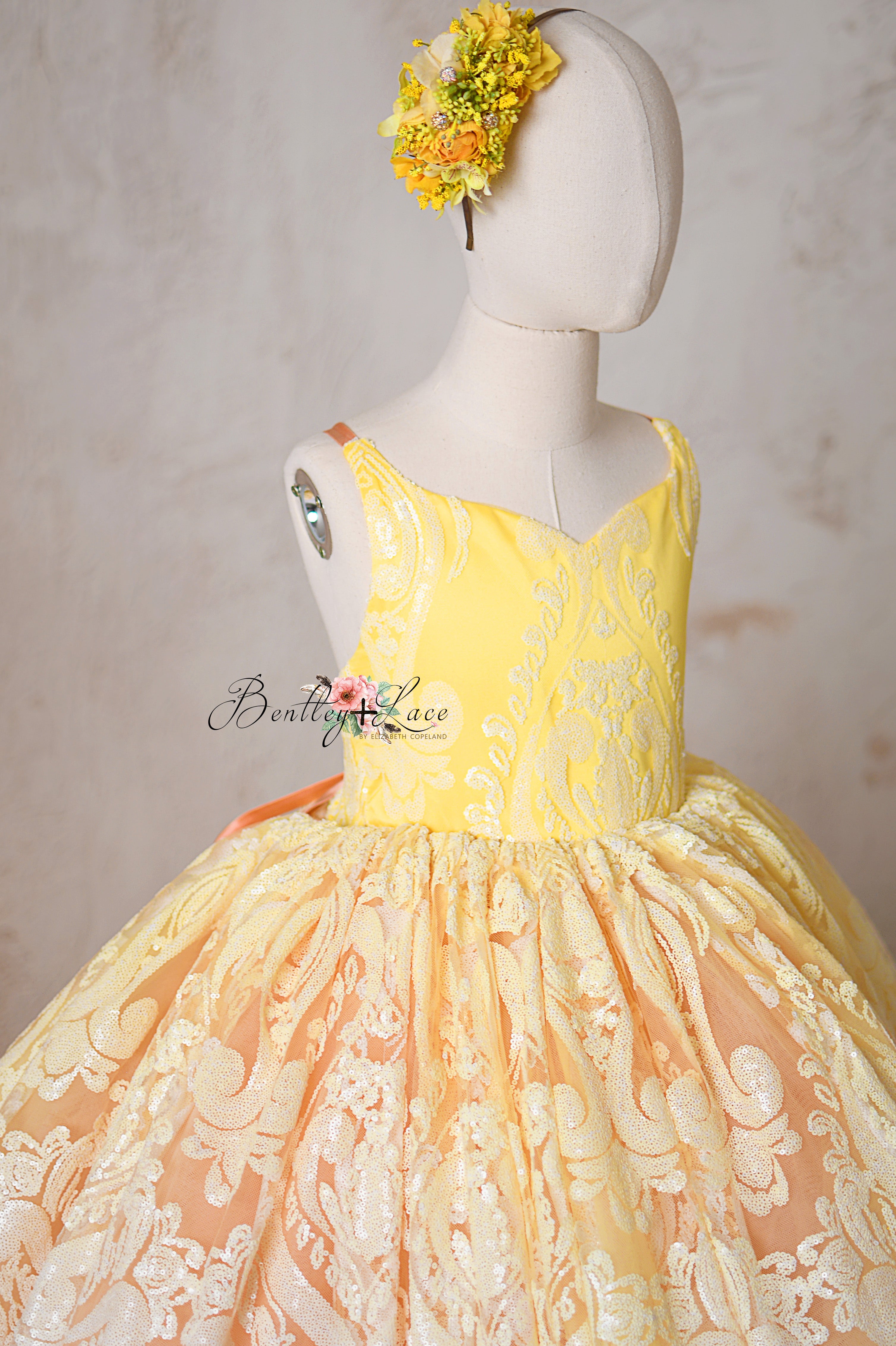 Delicate floral lace pattern on the "Sugar Kisses" coral and yellow gown.