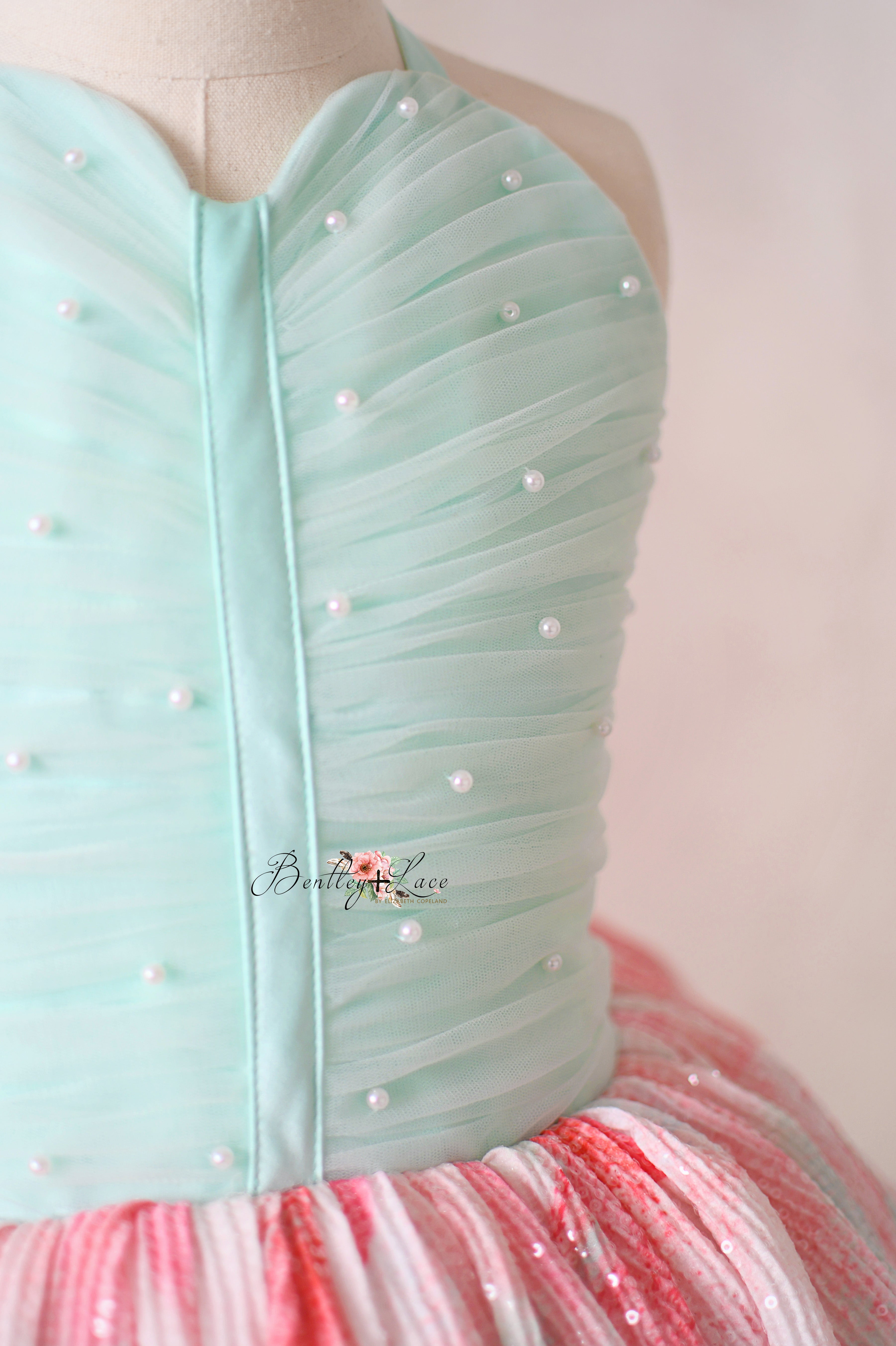 "Detailed shot of the hand-pleated bodice with delicate pearl embellishments on the Cotton Candy Dream gown."