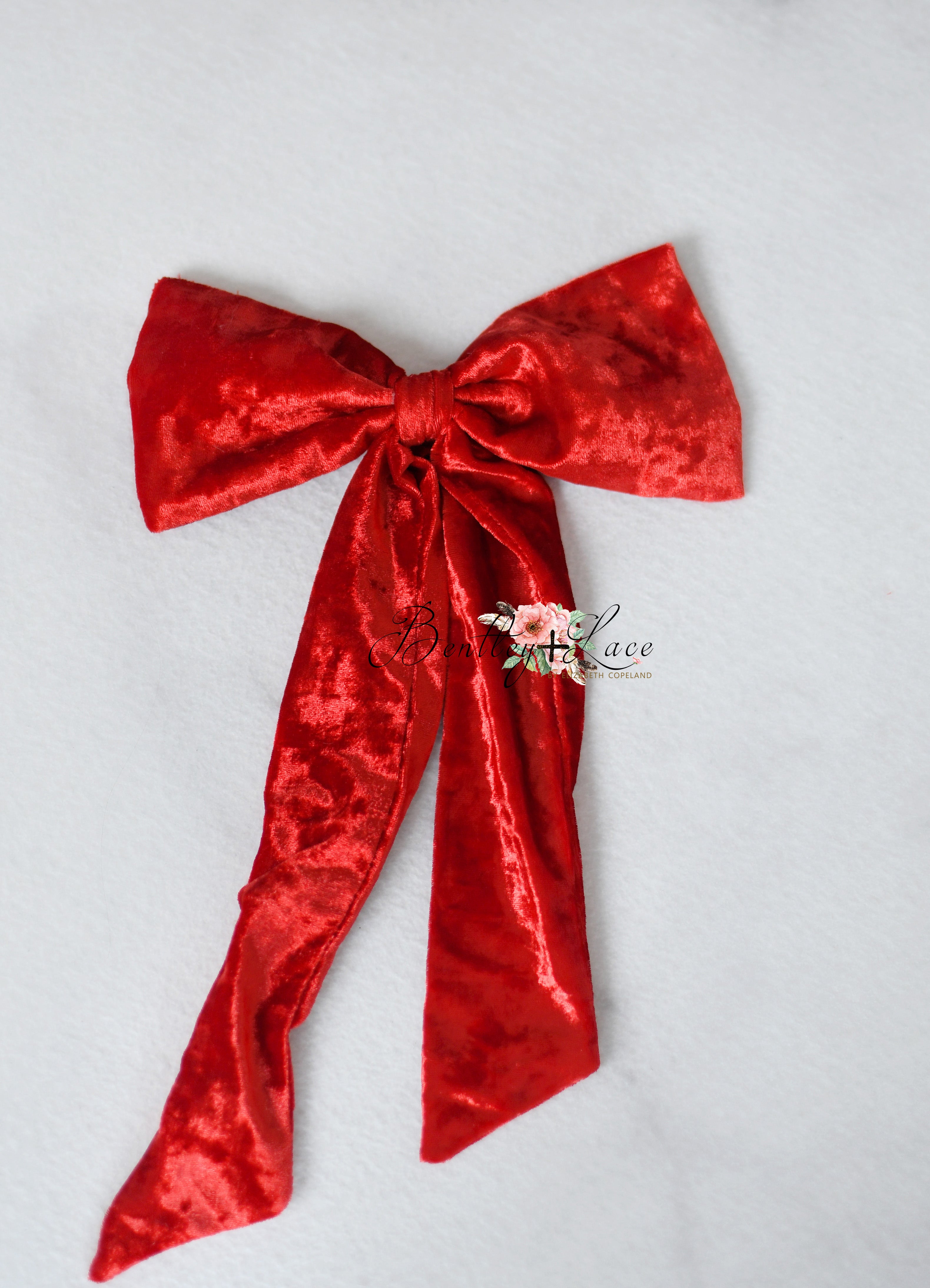Close-up of detachable velvet bow on Christmas gown