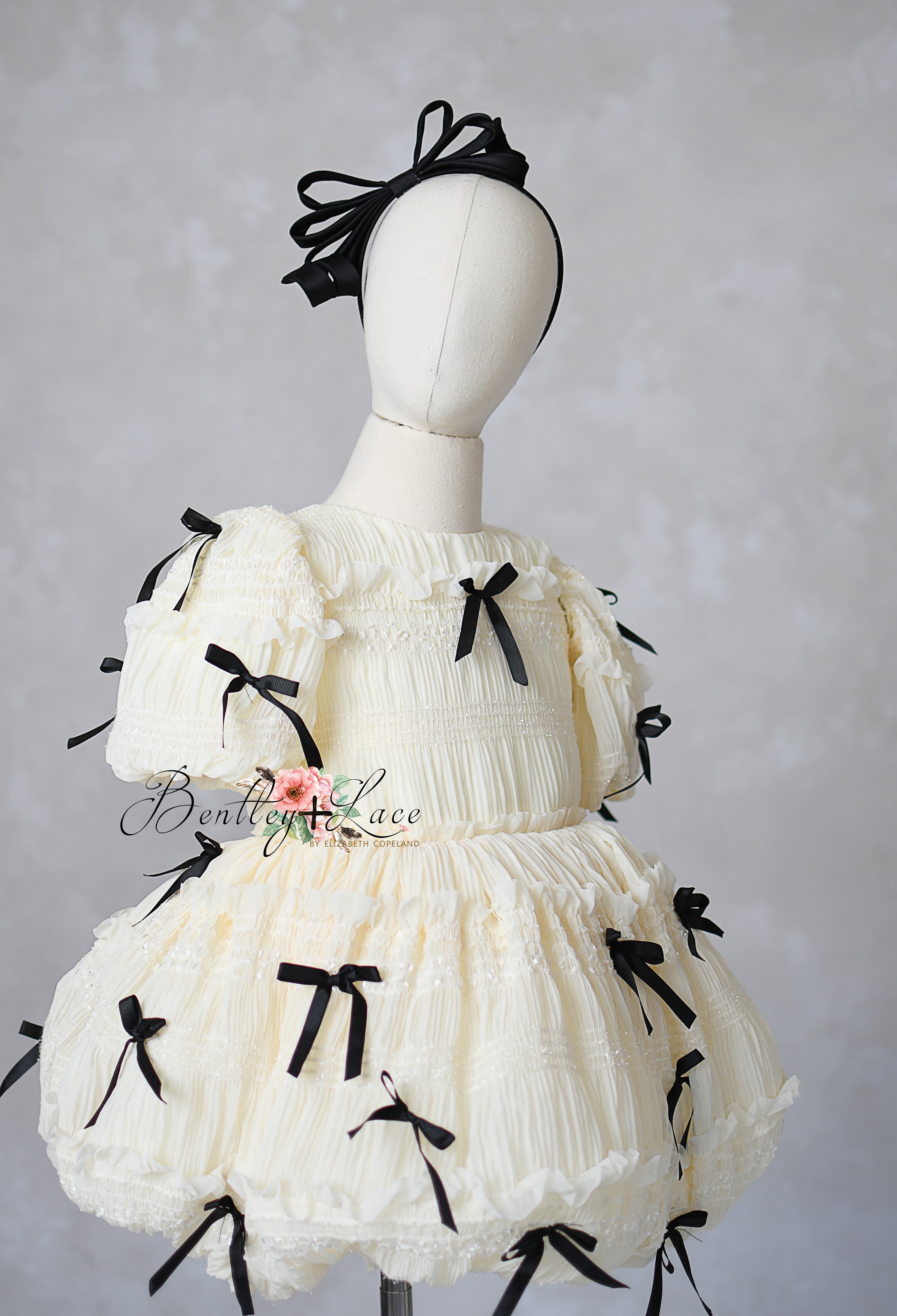Ivory smocked dress with black bows and puff sleeves for girls, ages 6–8 — Bentley and Lace couture gown.