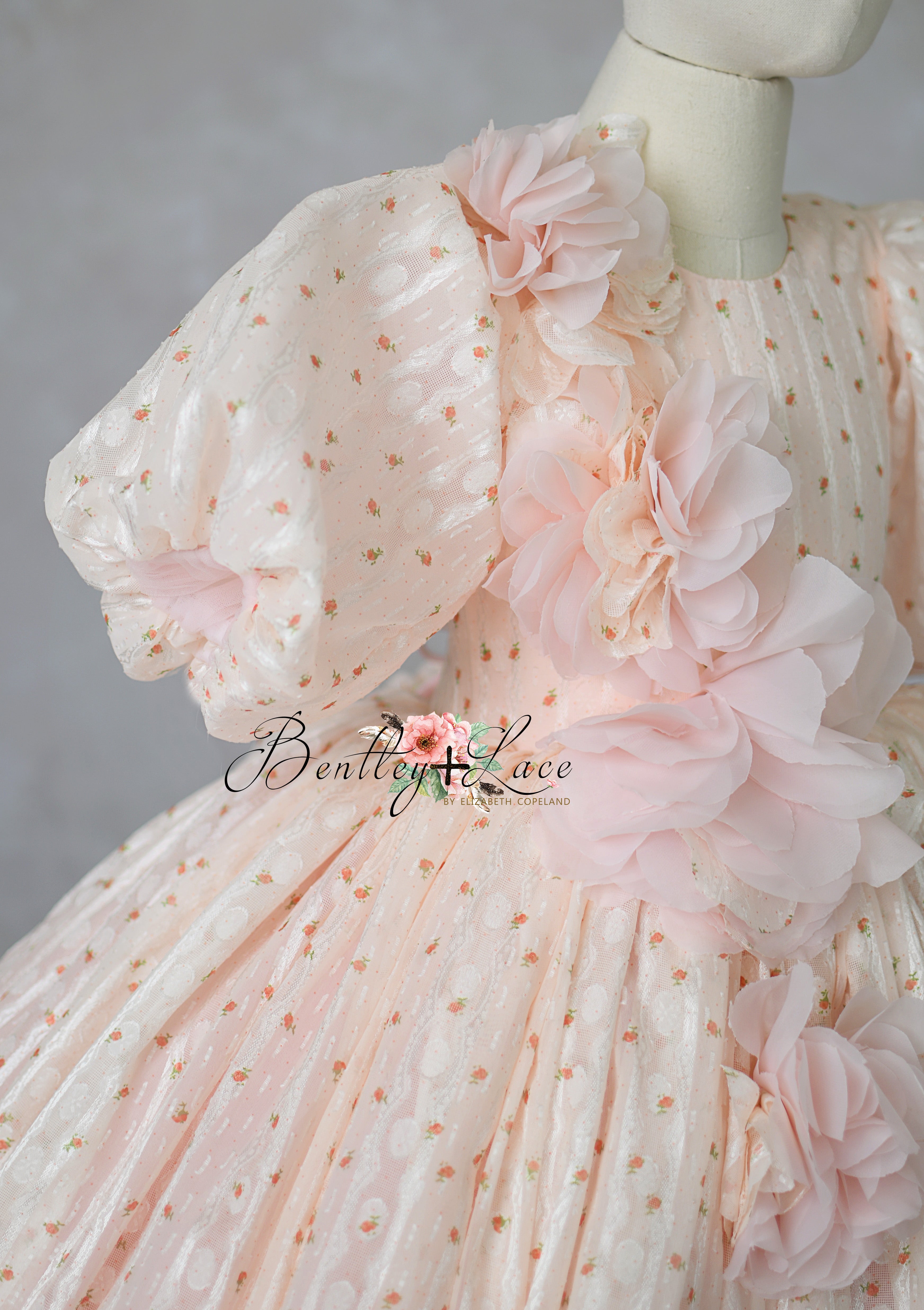 "High-end girls dress featuring voluminous skirt and floral detail"