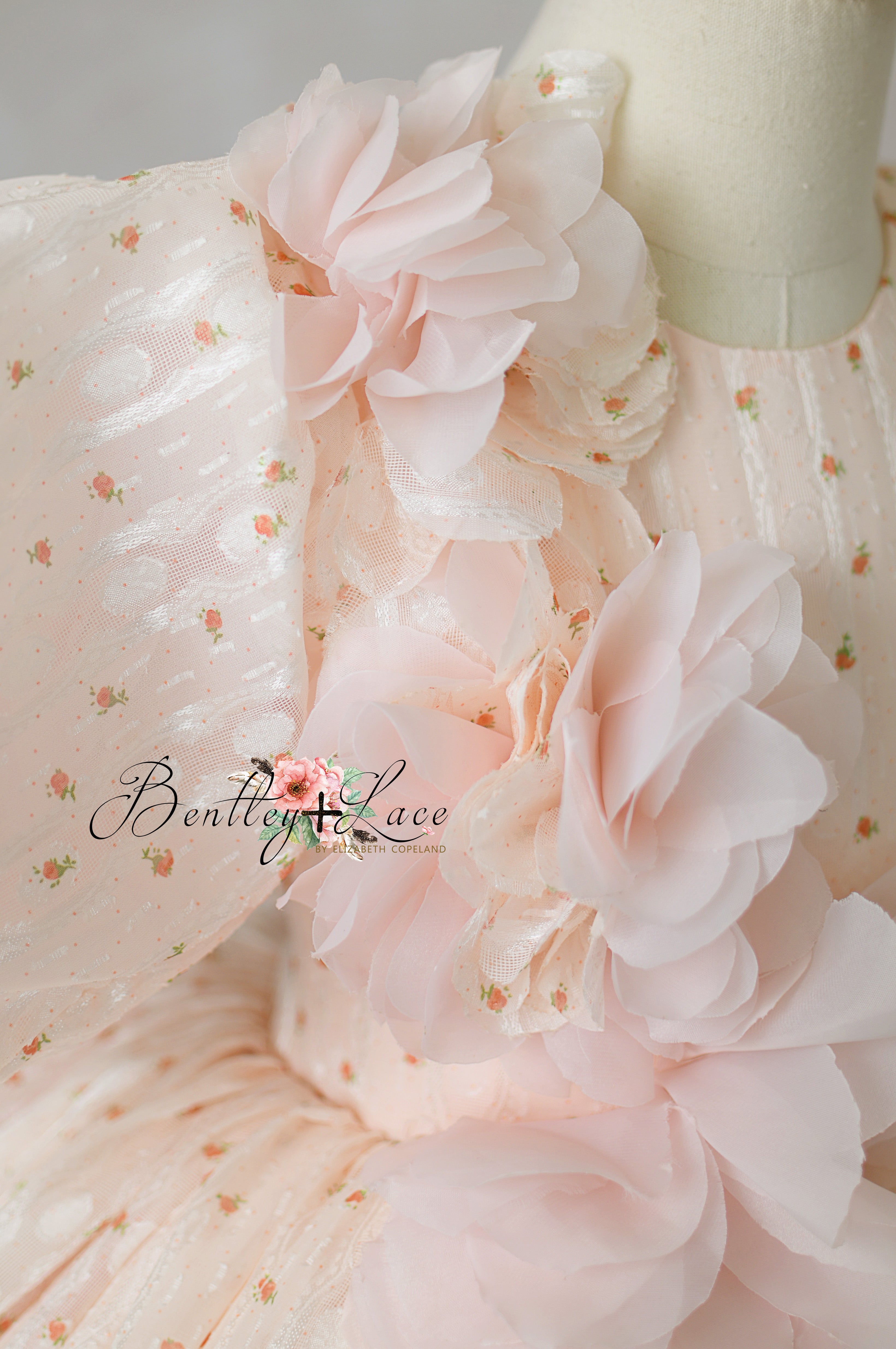 "Side view of elegant children’s formal dress with cascading rosettes"