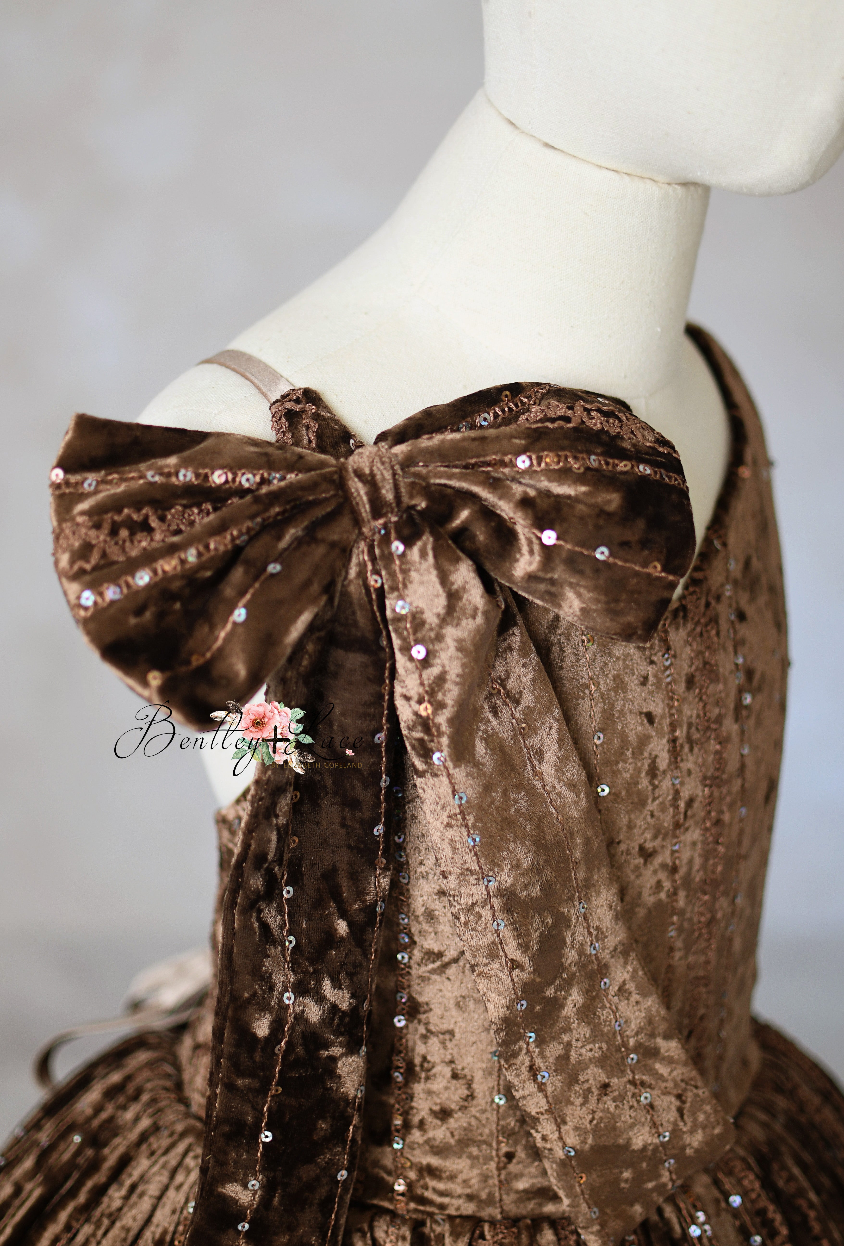 The bow tied stylishly on one adjustable shoulder strap for a playful look.