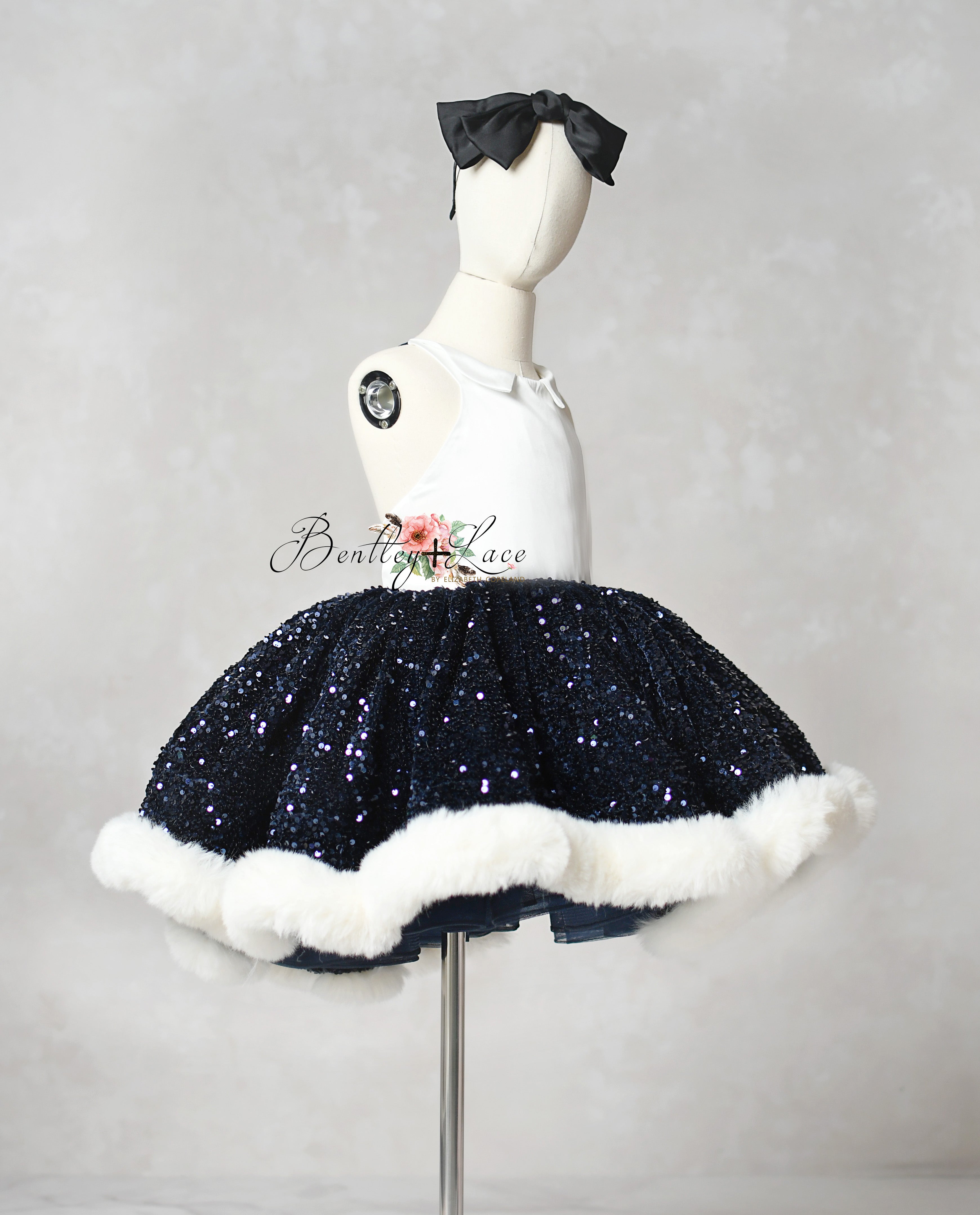 Navy blue sequin skirt with white trim on a mannequin against a gray background