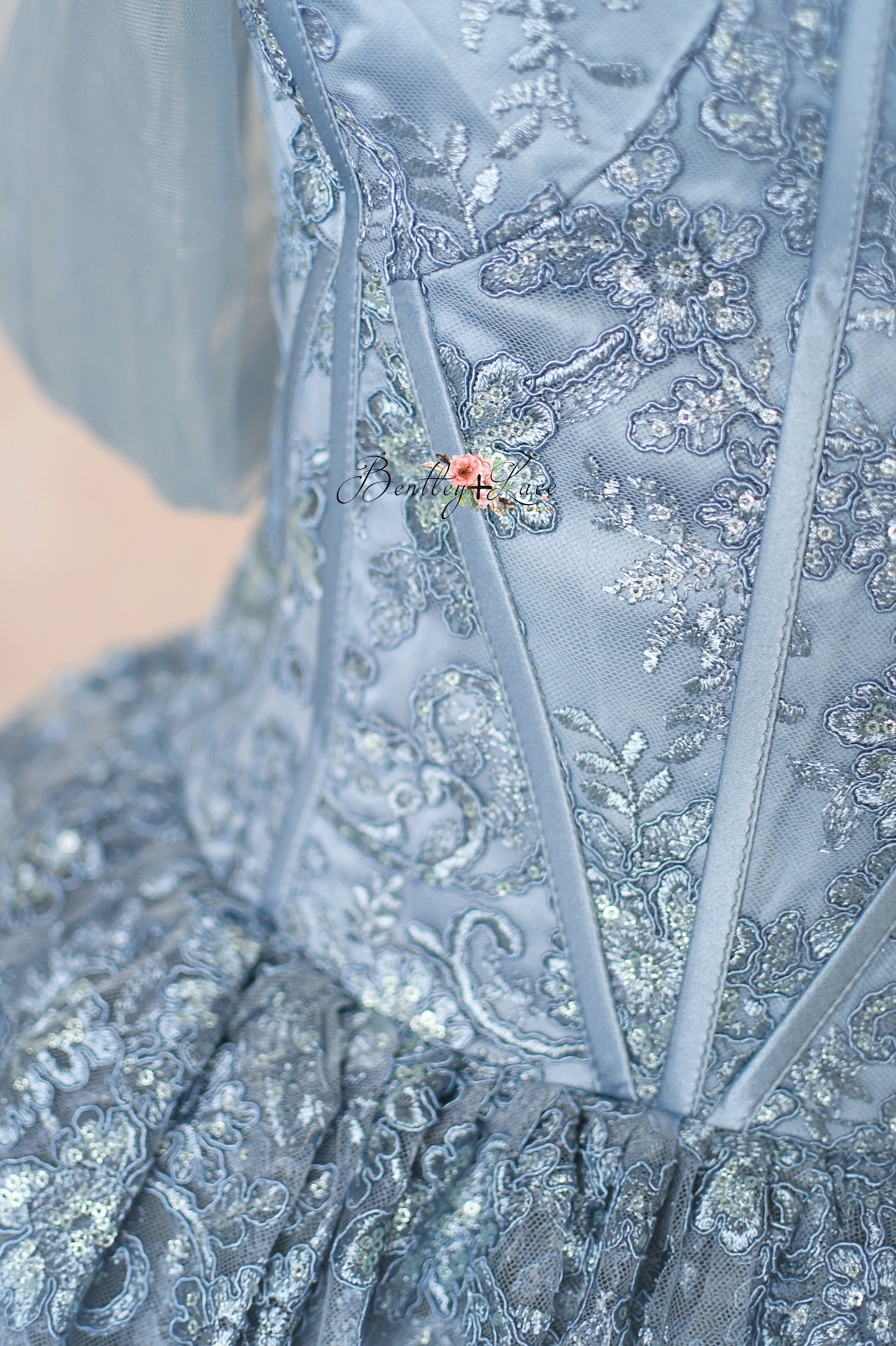 Close-up of a blue embroidered garment with floral details.