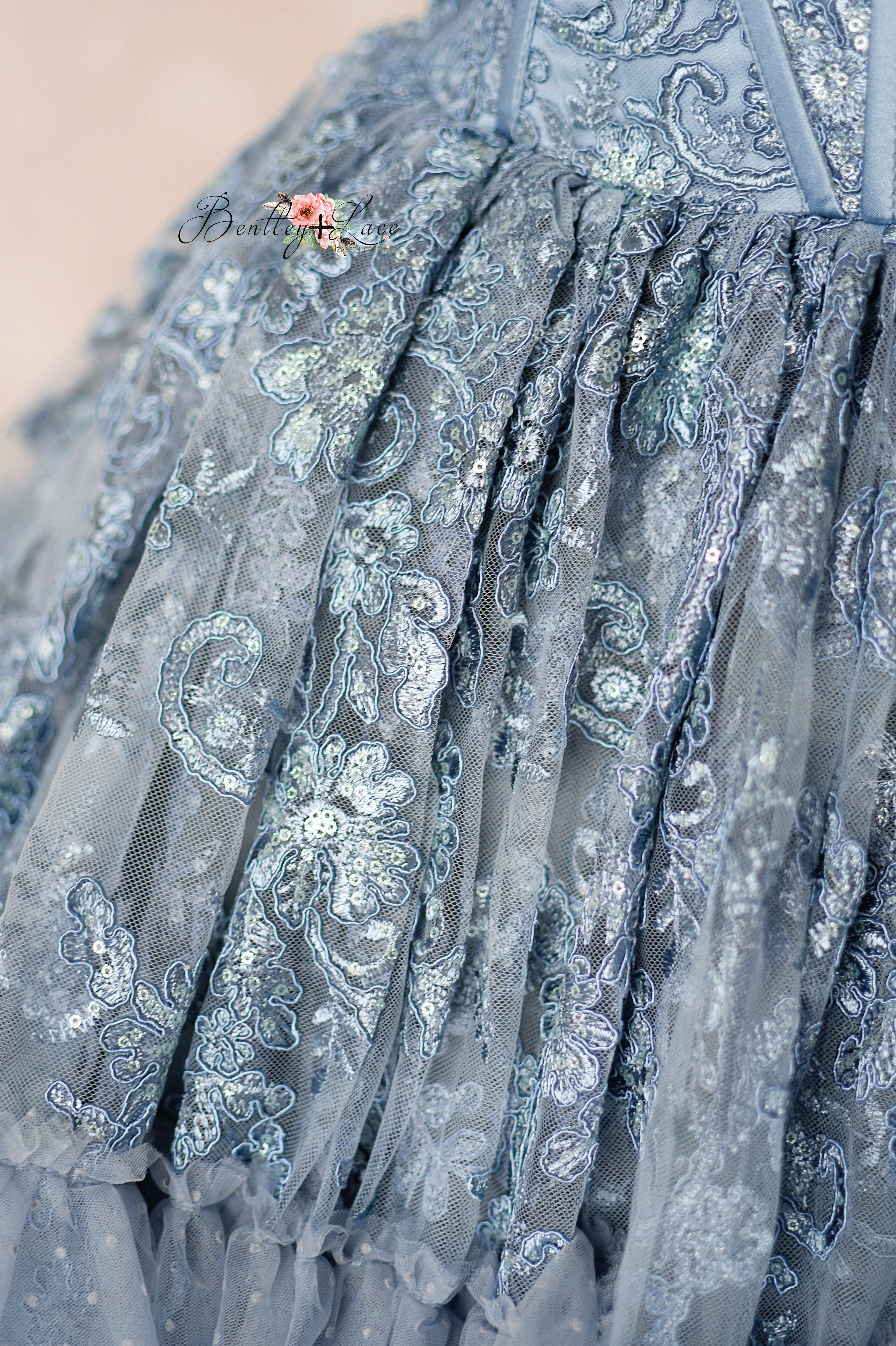 Close-up of a blue embroidered fabric with intricate patterns