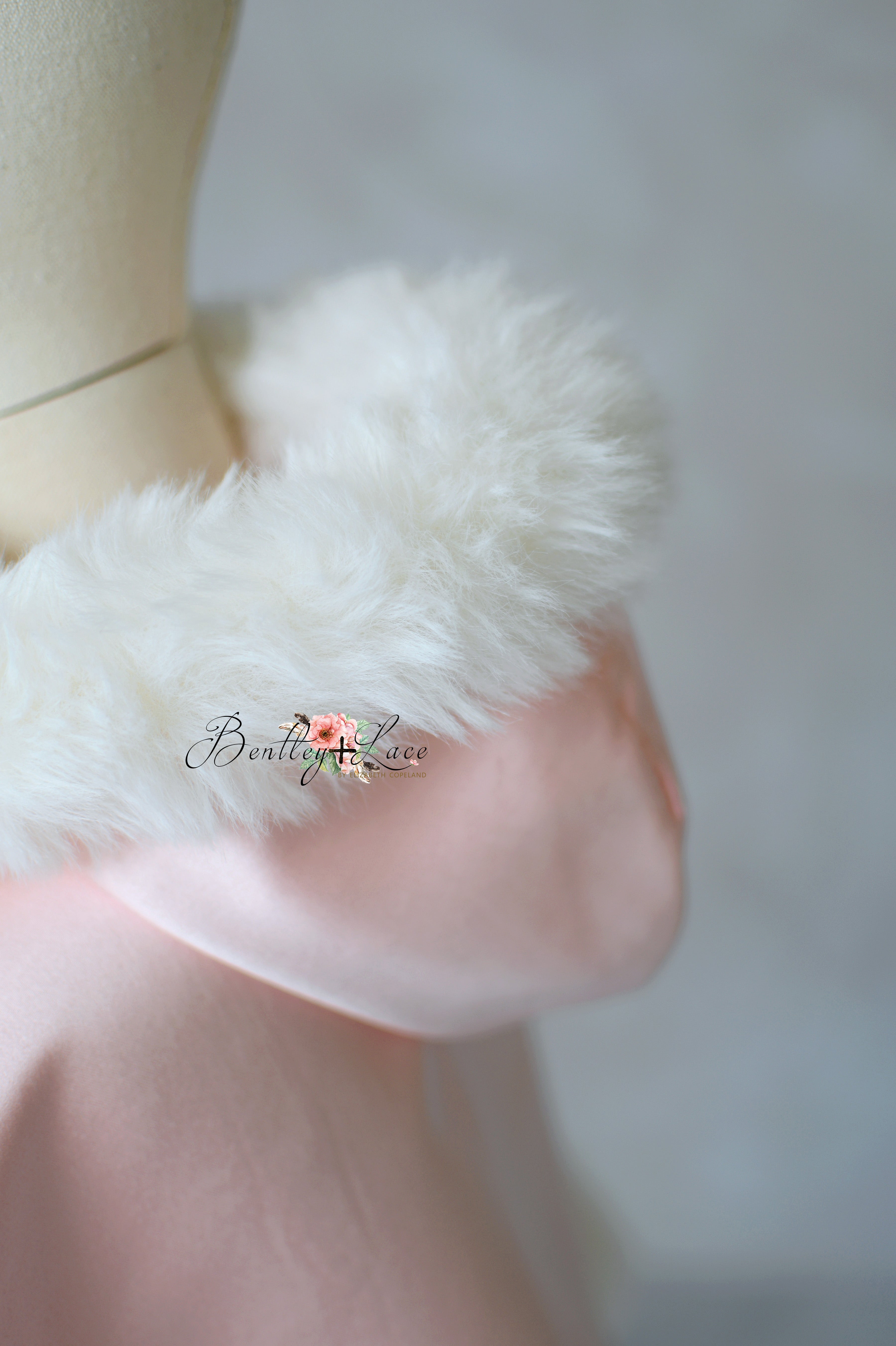Close-up of a white fluffy object on a blurred background with 'Boutique Love' branding.