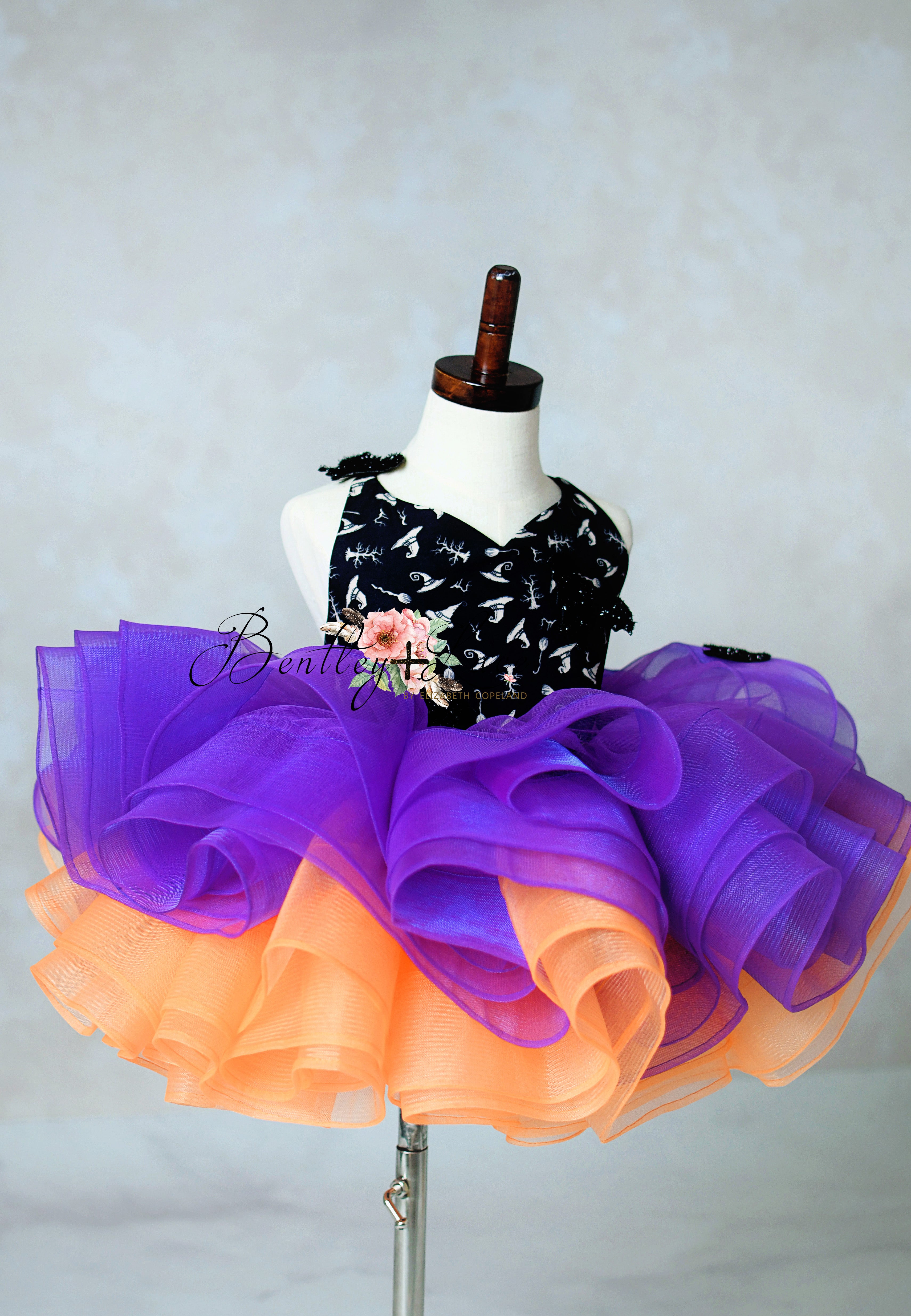 Colorful tutu dress on a mannequin against a plain background