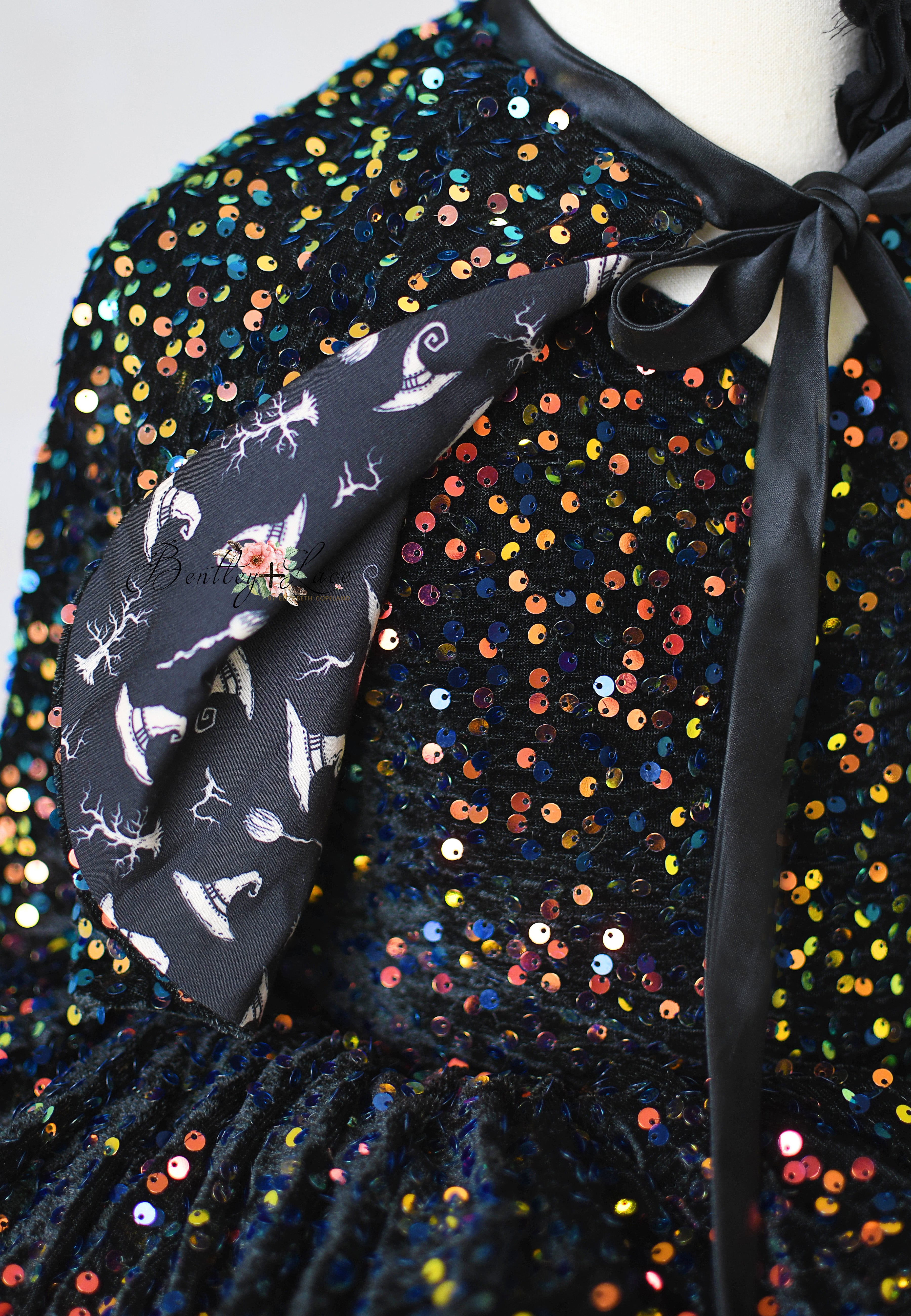 Sequined garment with a black scarf featuring foxes and flowers on a white background