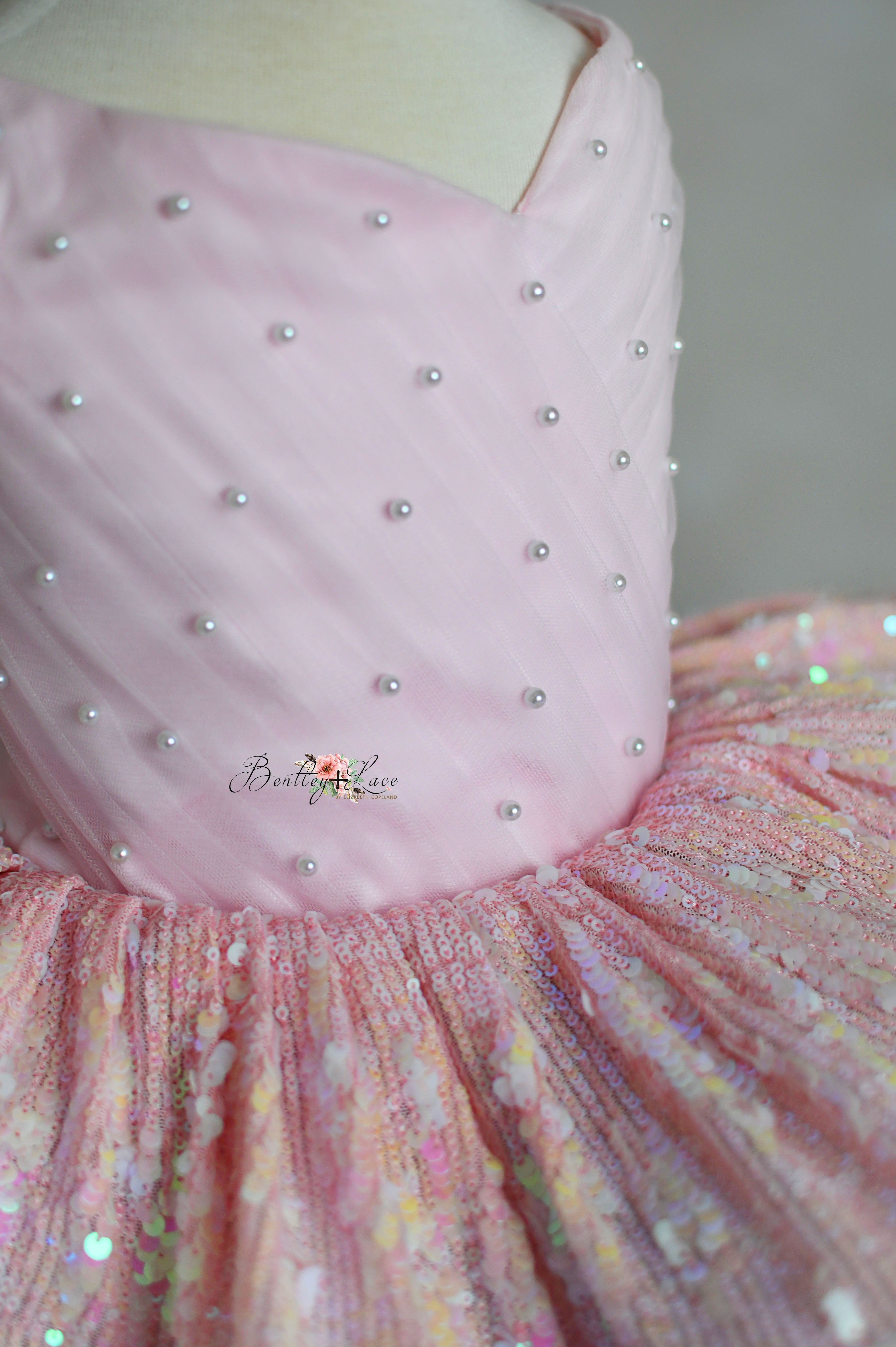 Stylish 'Speak Now Gown' with pink sequins, rainbow tulle, and adjustable ties, perfect for young Swifties.