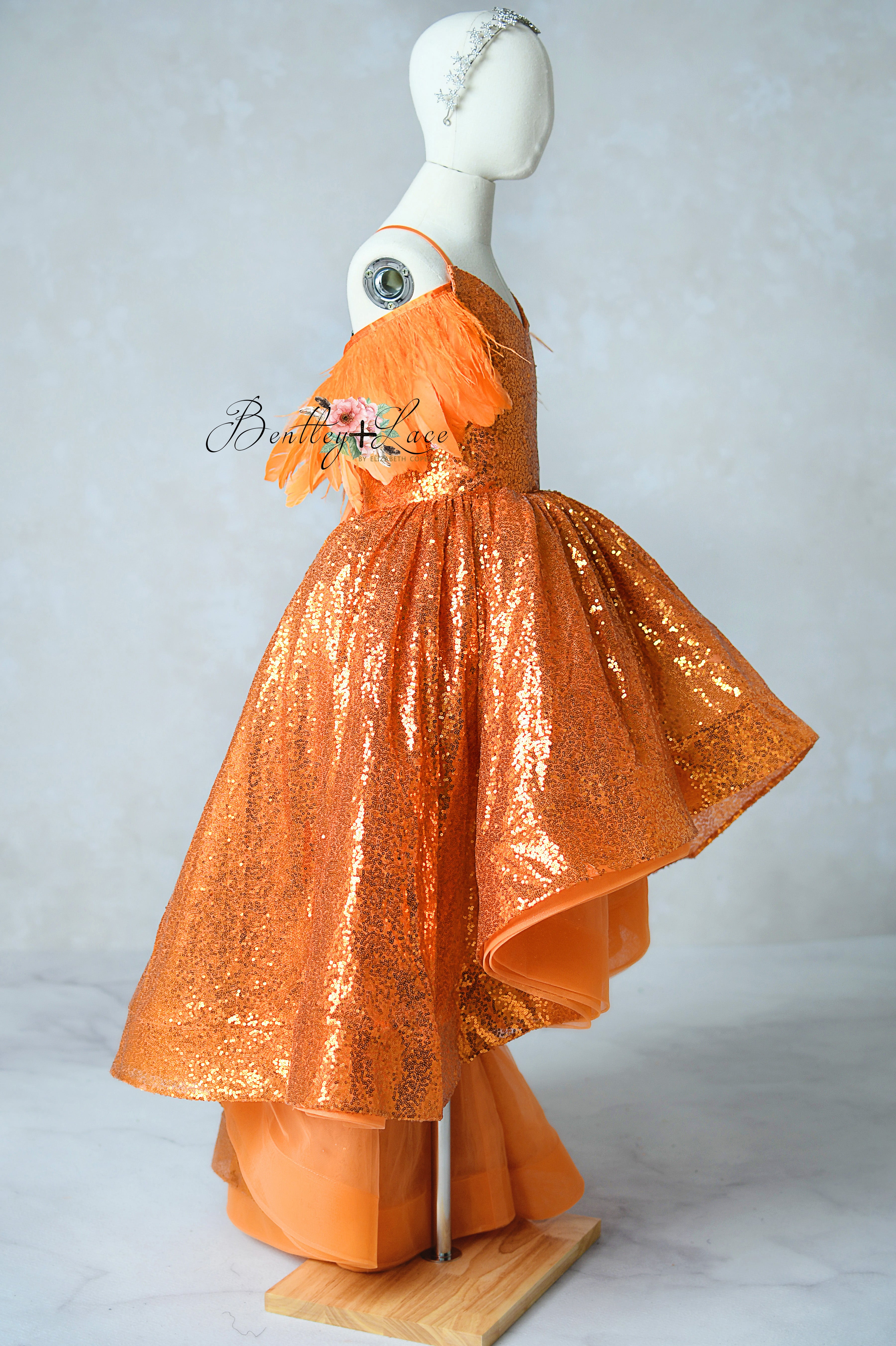 Girls’ orange sparkle party dress with high-low hemline and versatile styling options