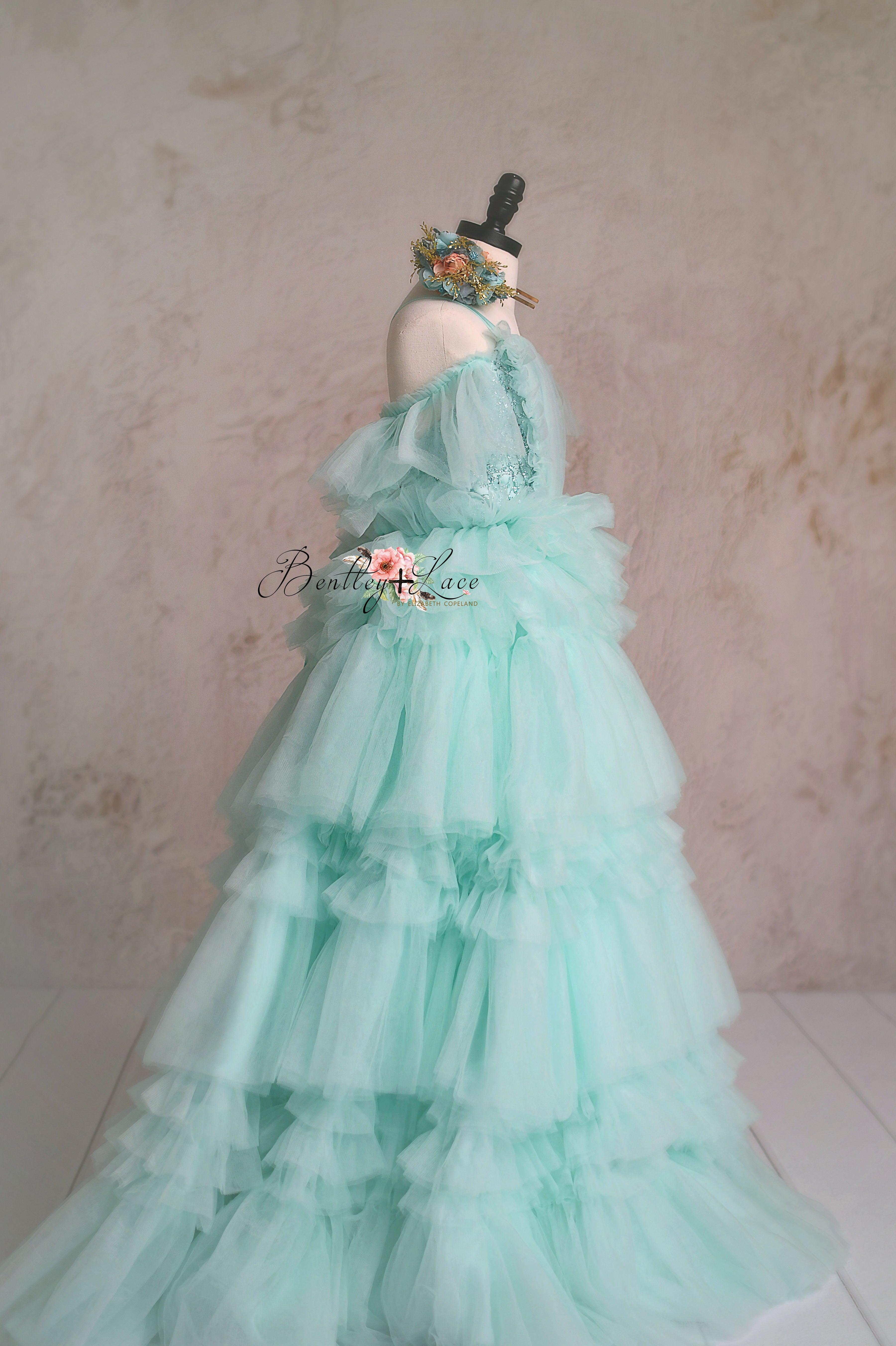 Side view of a multi-layered aqua tulle dress for girls.