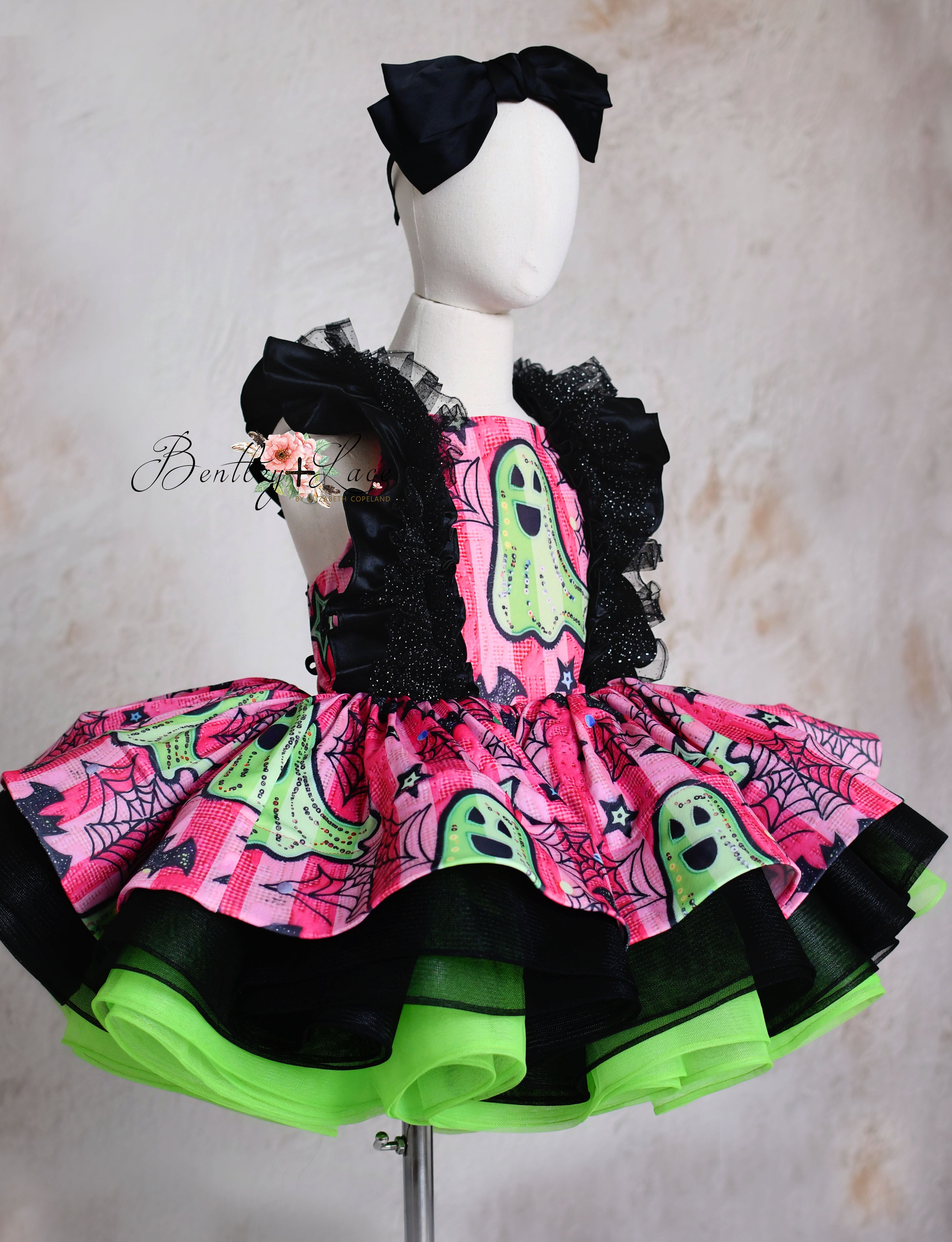 Custom Halloween ghost-themed dress featuring bold pink and green accents, designed for children