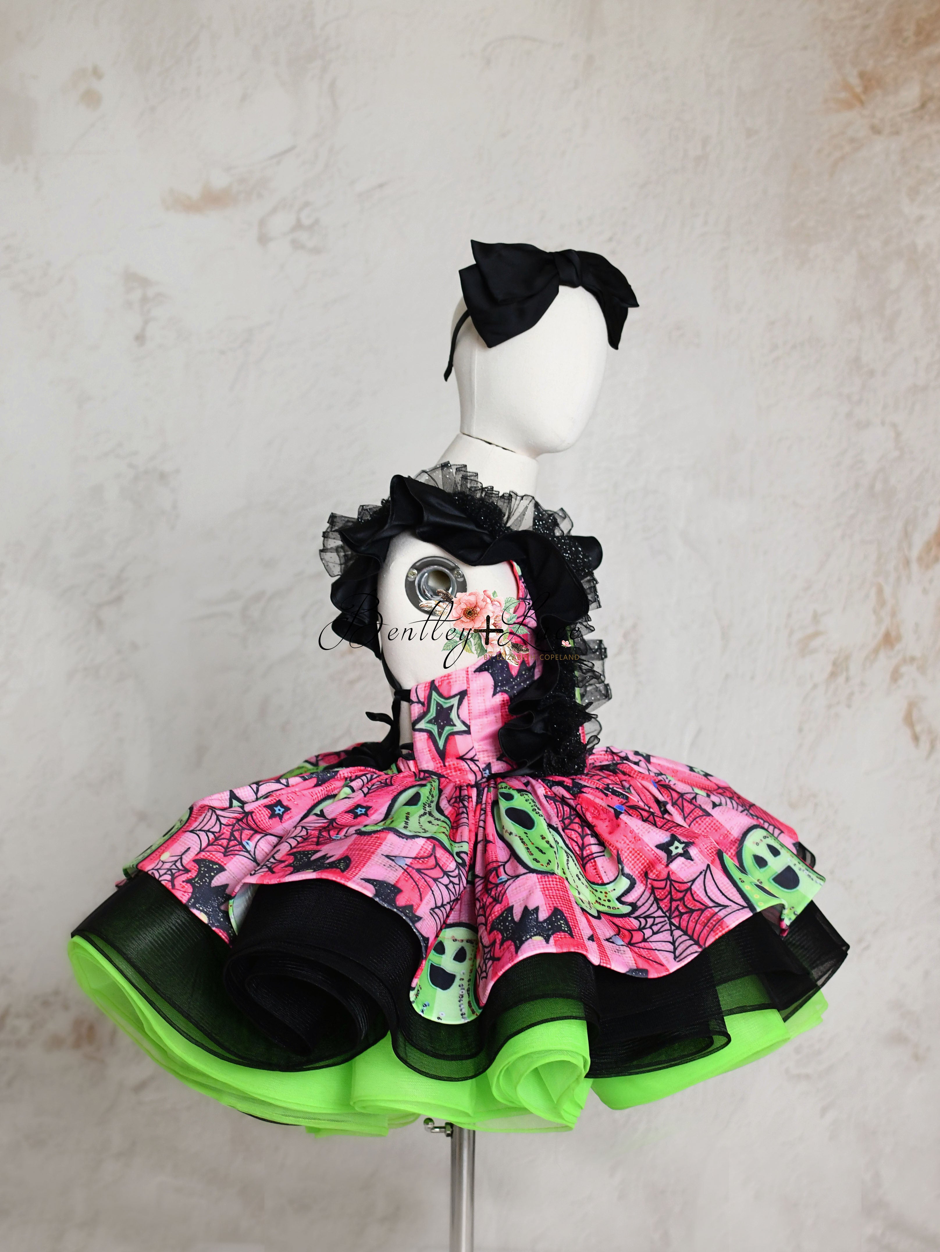 “Custom Halloween dress with ghostly patterns in bold pink and green, perfect for festive events”