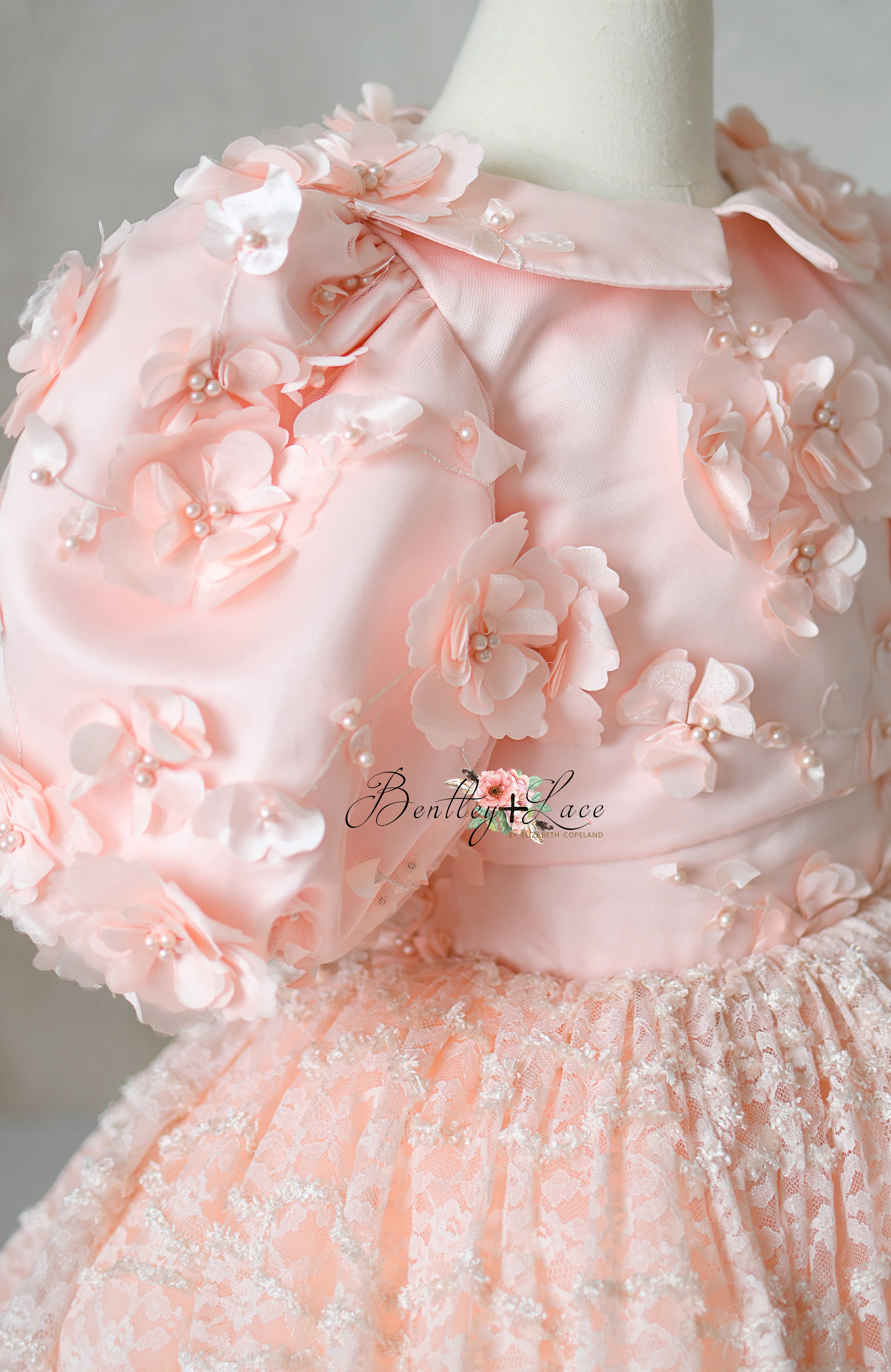 Rosette Reverie gown with detachable floral appliqué capelet.