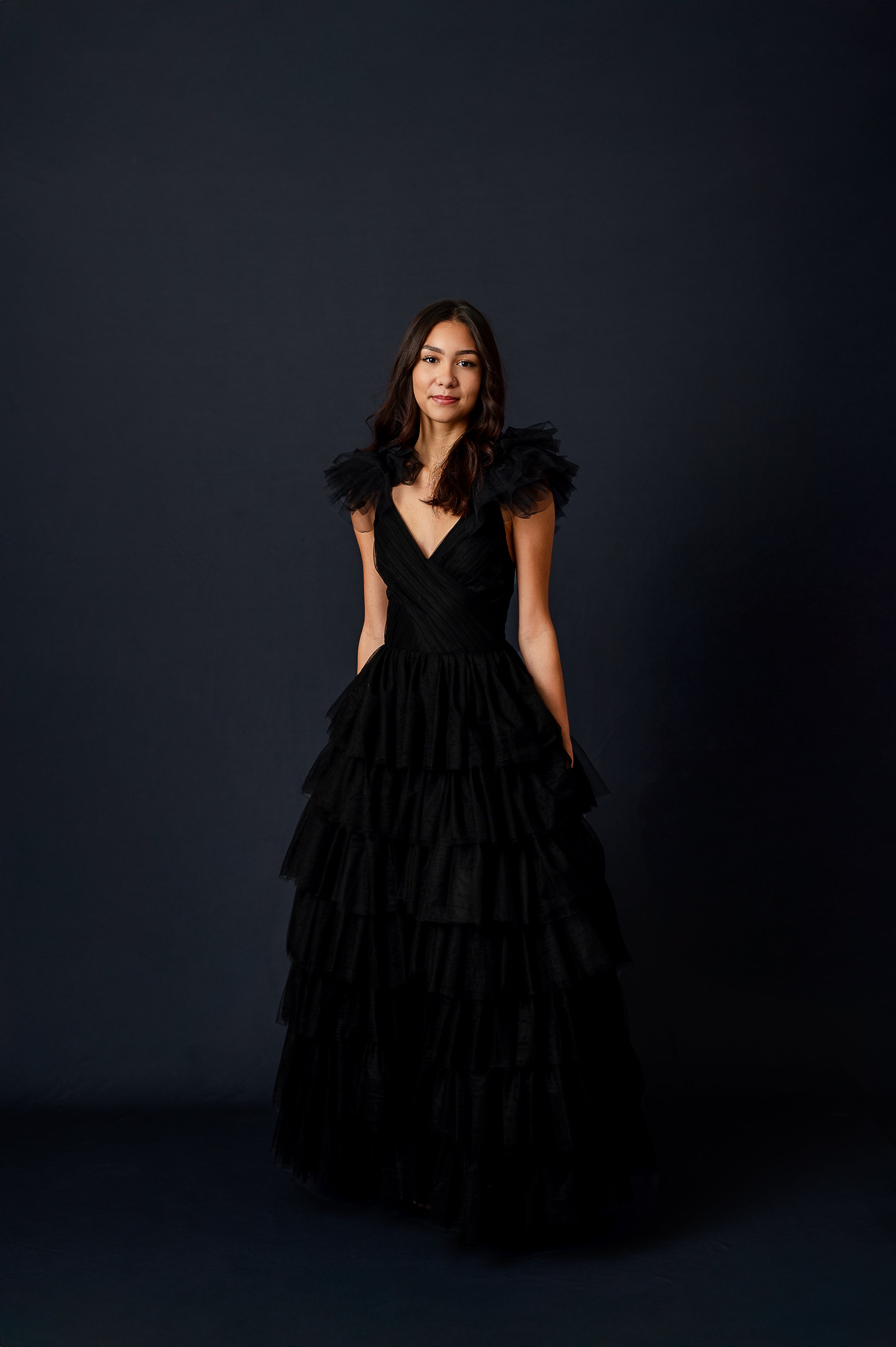 Close-up of the Noir Reverie gown's ruffle shoulder details and fitted bodice.
