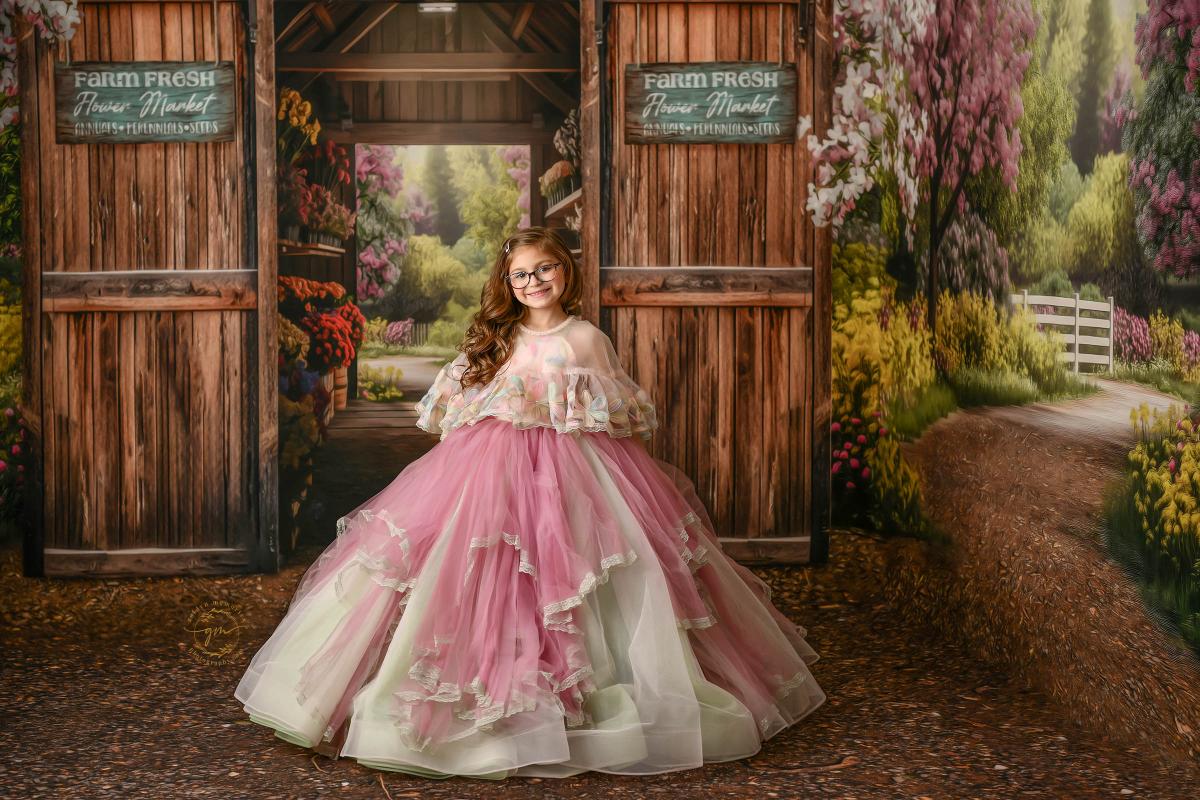 "Little girl wearing a pastel floral gown, surrounded by nature."