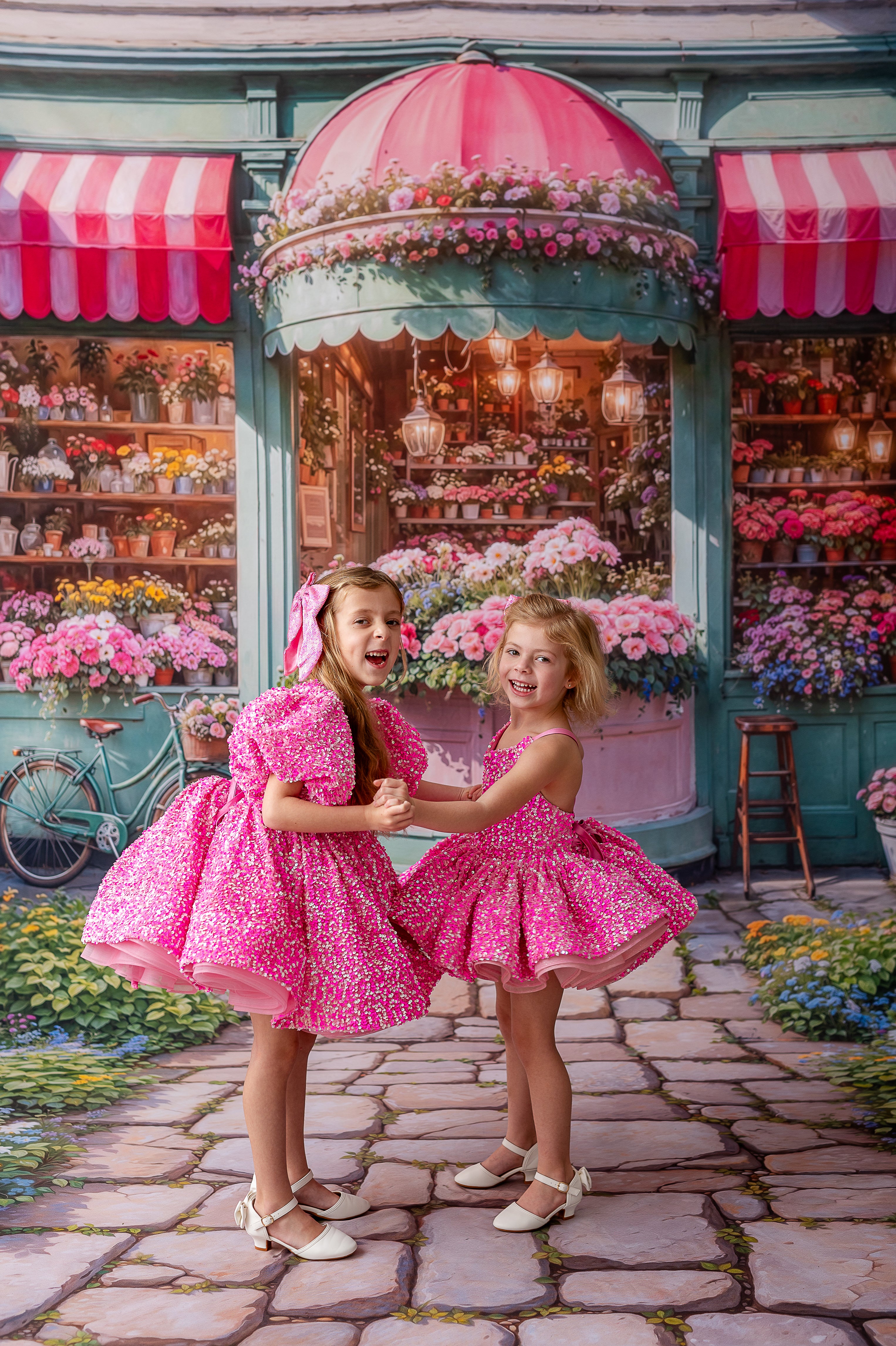 Playful young girls in glittering pink and rainbow dress, ideal for parties and special occasions.