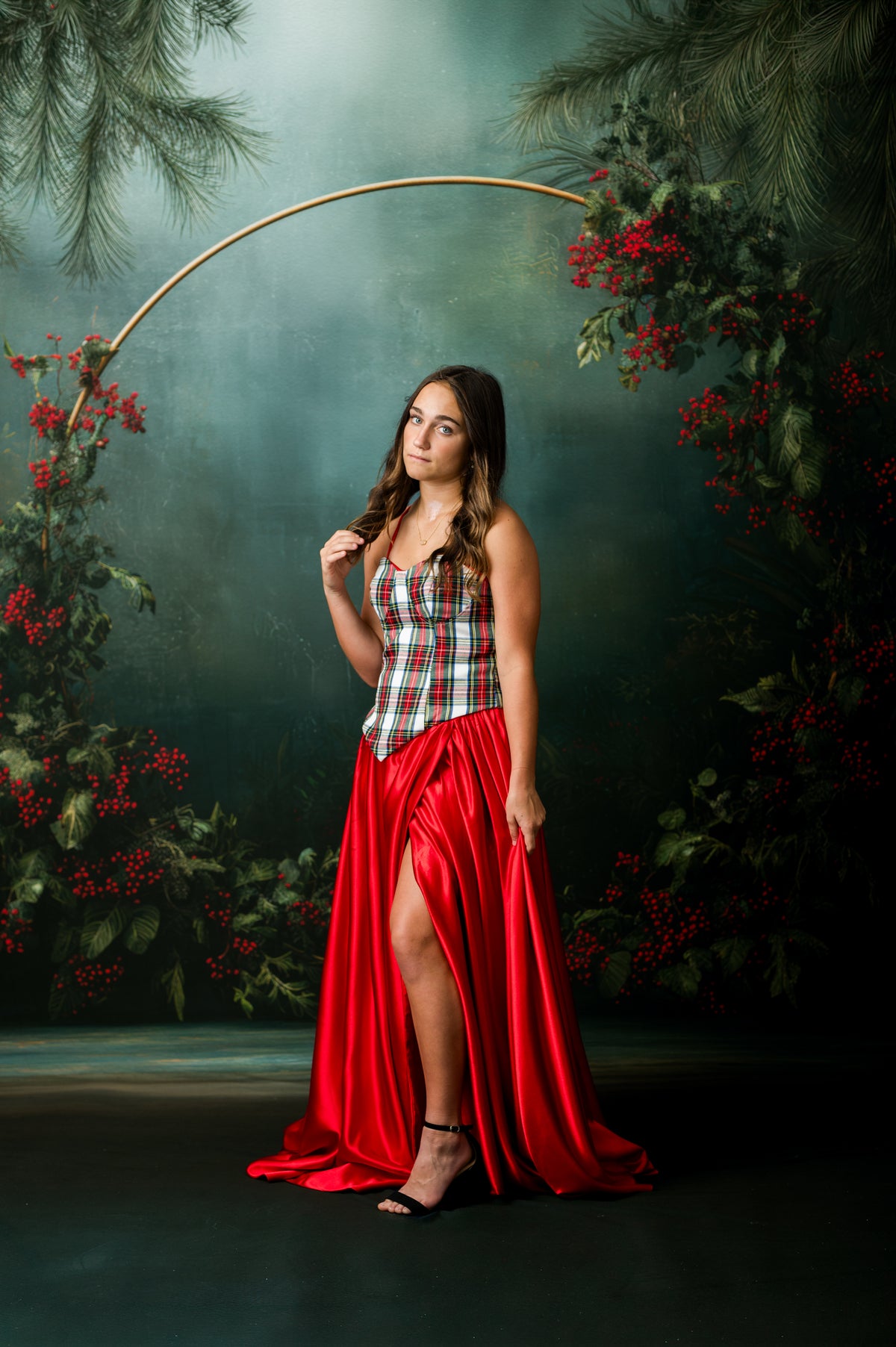 Teen Christmas couture look featuring plaid corset bodice and dramatic red satin skirt