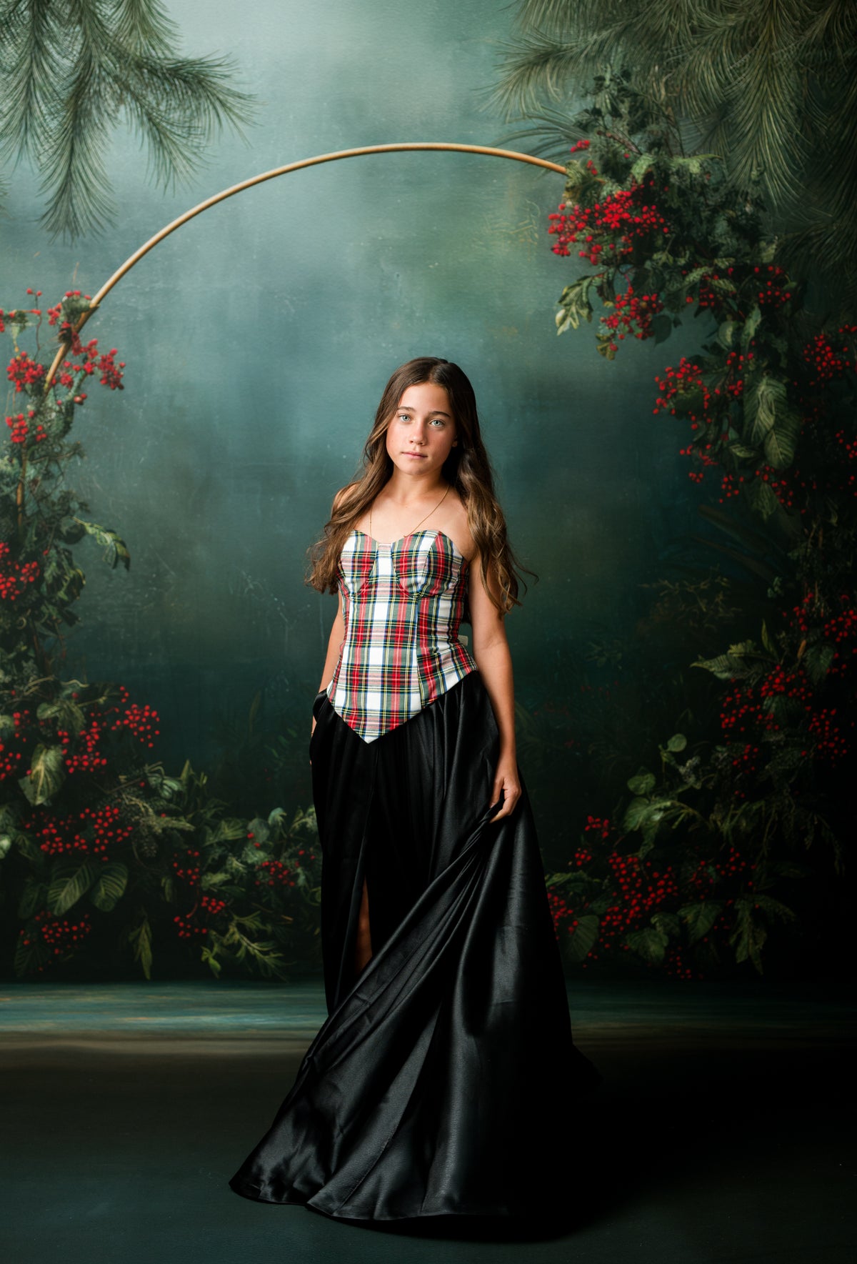 Teen holiday portrait in plaid corset and flowing black satin floor-length skirt