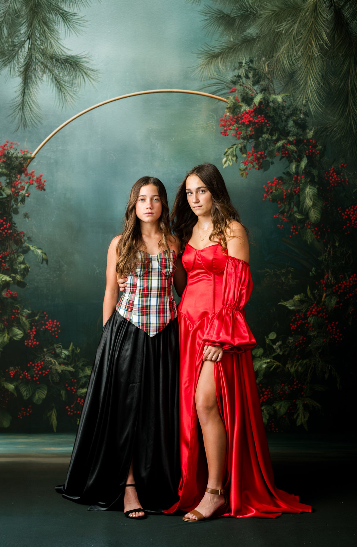 Teen model wearing the Holly and Tartan red satin Christmas rental gown by Bentley + Lace