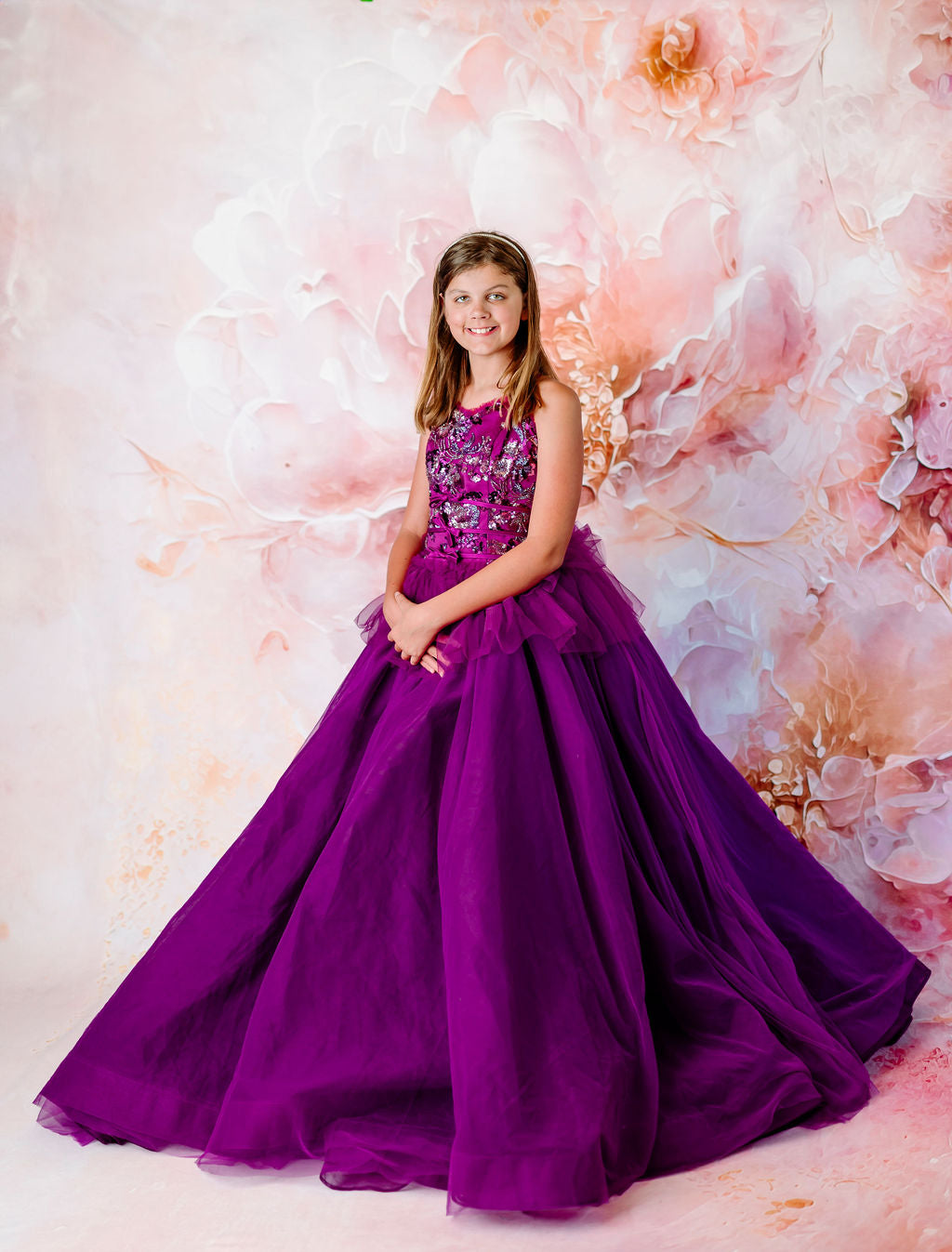 Elegant beaded bodice on a layered purple gown for girls.