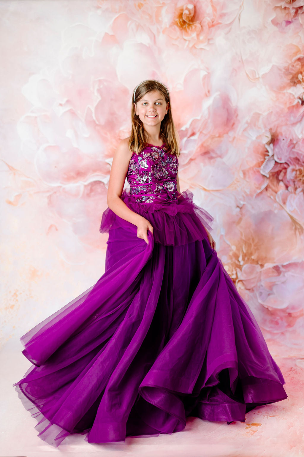 Girl in a vibrant purple gown with delicate floral accents.
