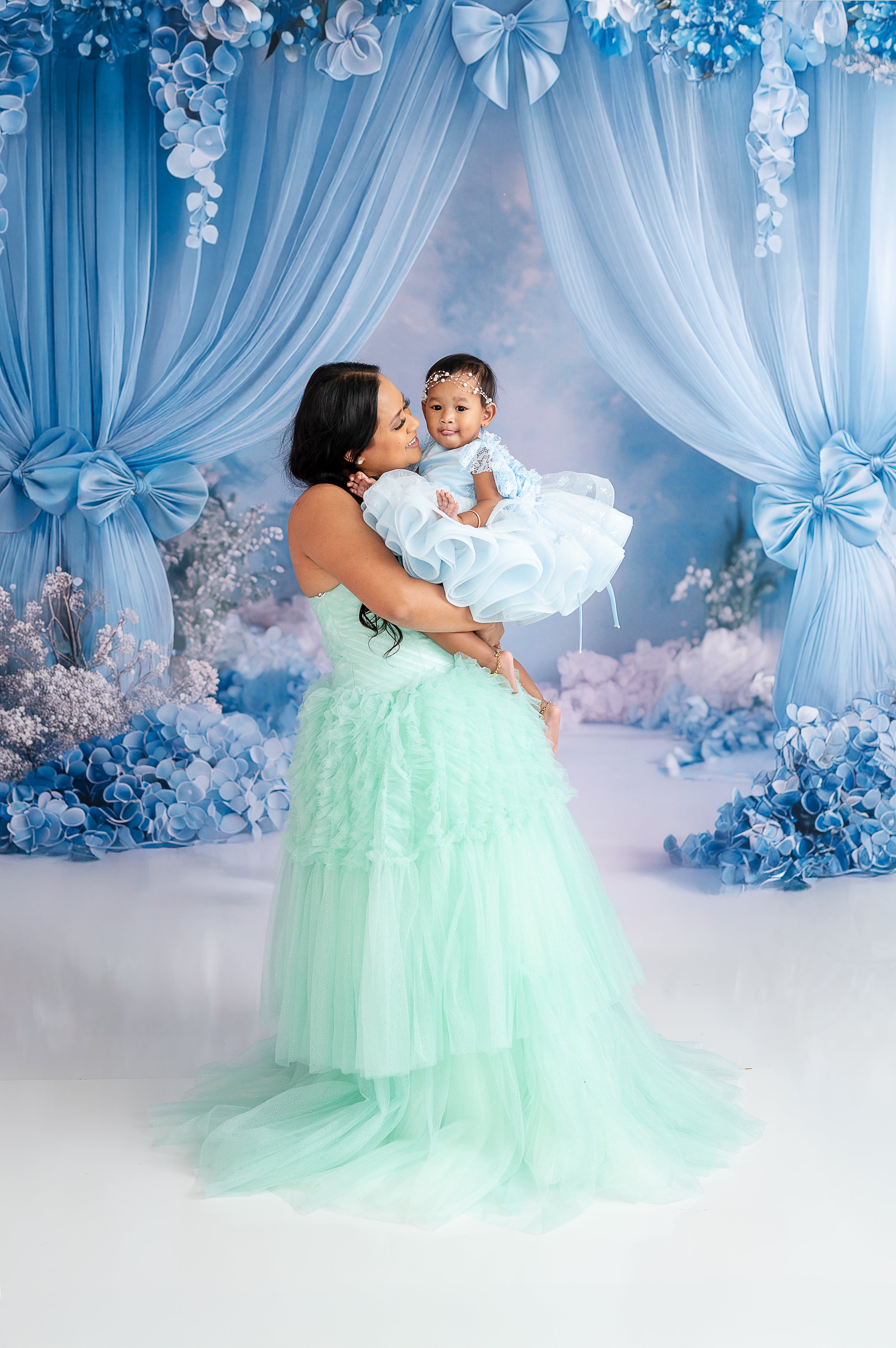 "Soft hues of blue and green blend beautifully in this mother-daughter fashion portrait."