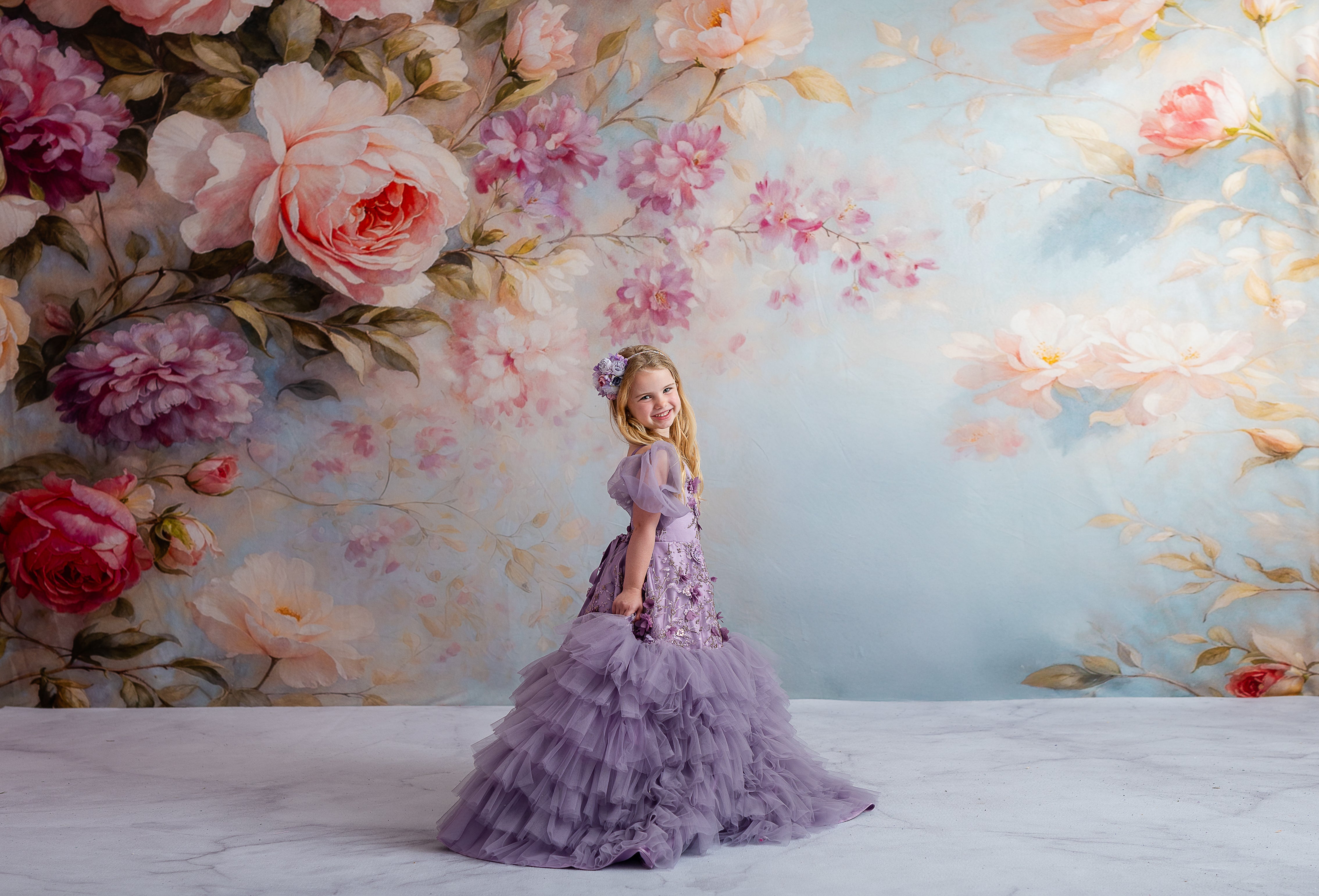 Elegant children’s gown with lavender tulle, floral appliqués, and versatile sleeve design.
