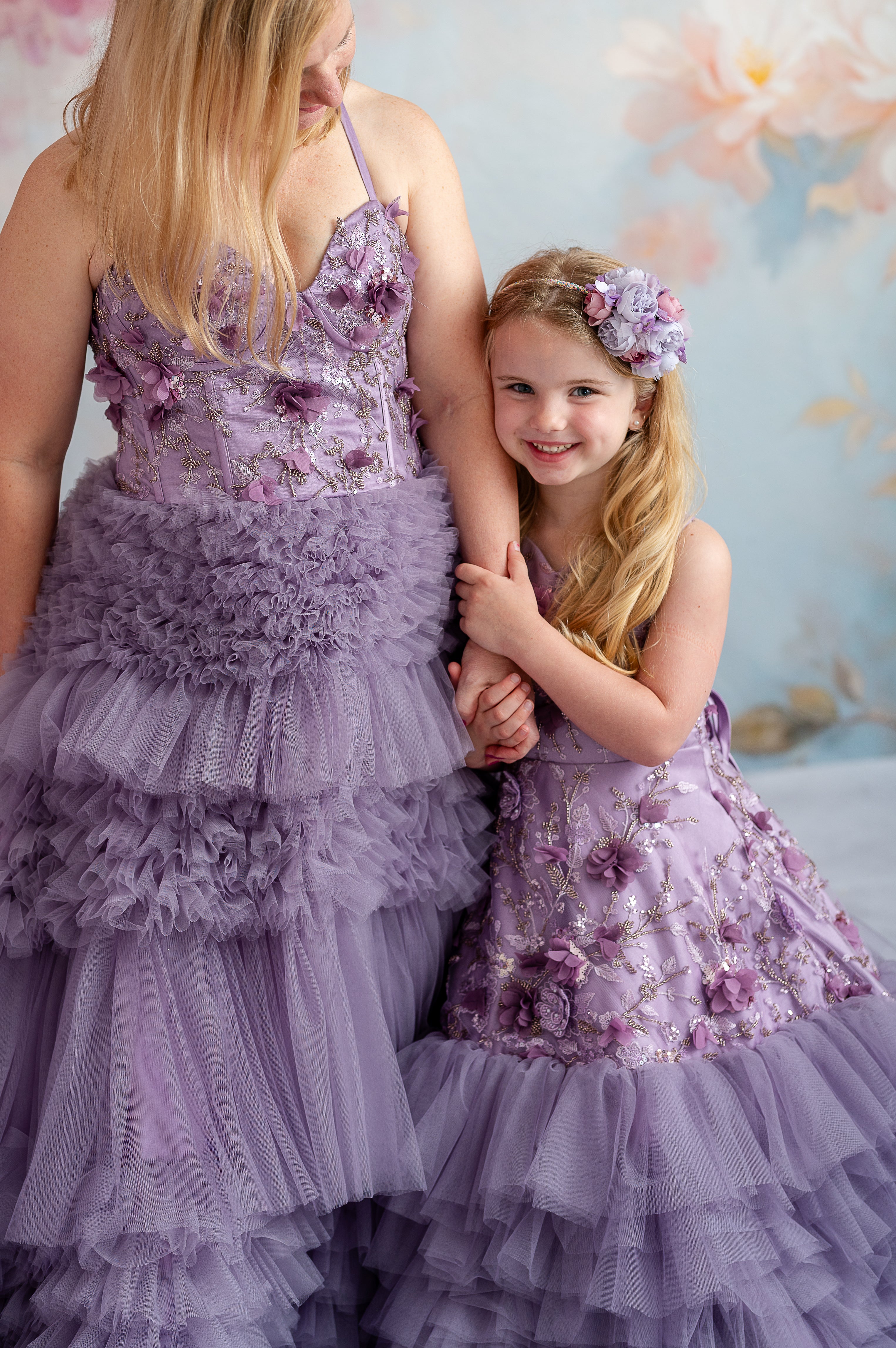 Dreamy mommy and me photo with flowing lavender gowns and hand-sewn floral appliqués.
