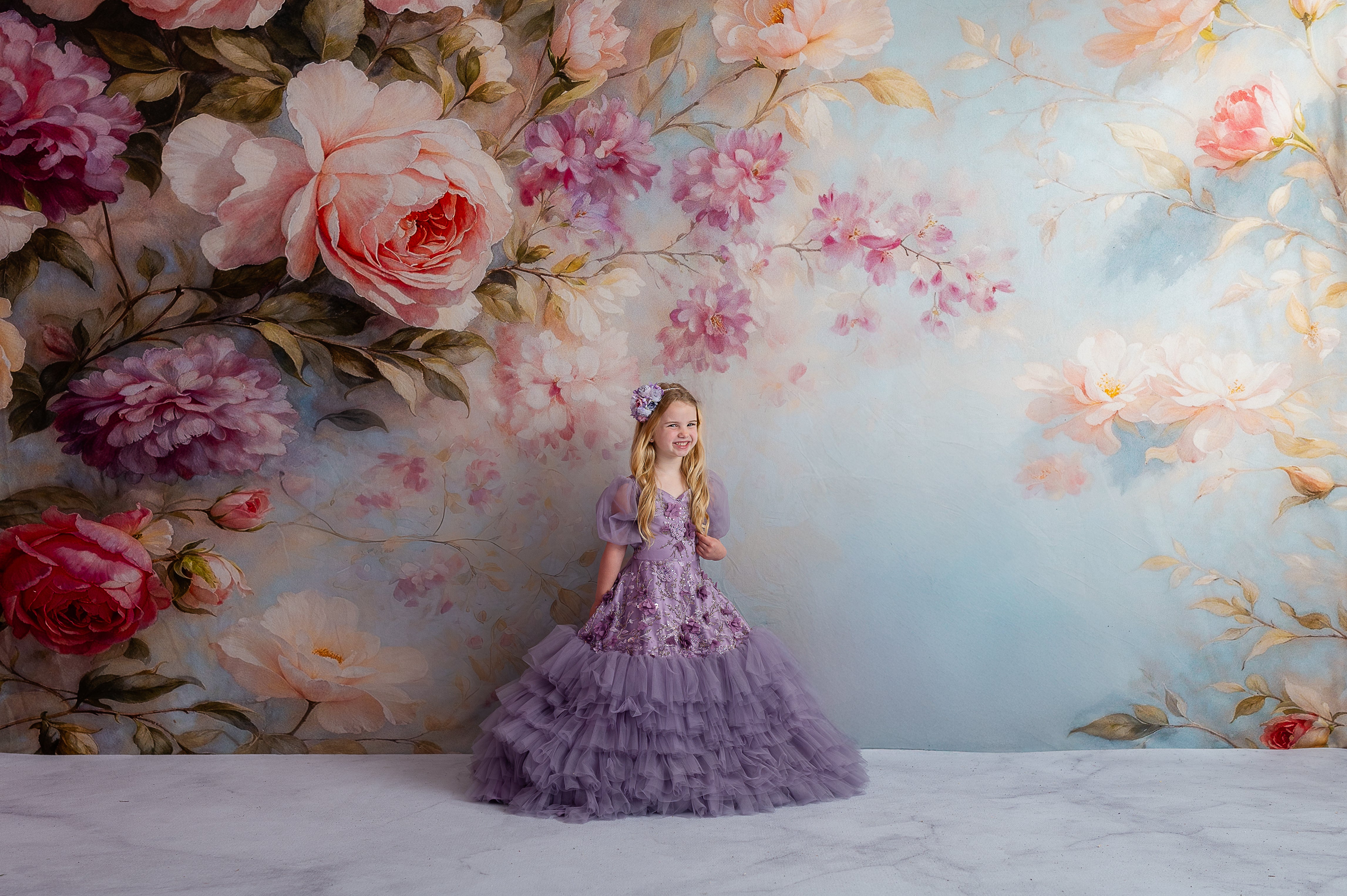 Styled children’s gown with lavender tulle, 3D floral appliqués, and removable puff sleeves.
