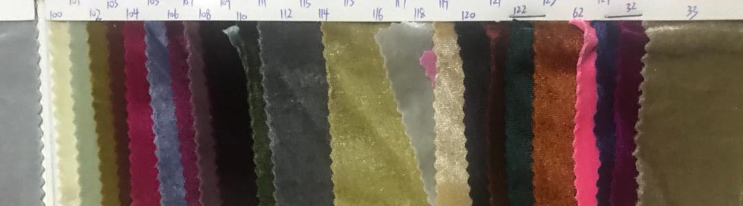 A selection of velvet fabric swatches in various colors, intended for custom dress making.