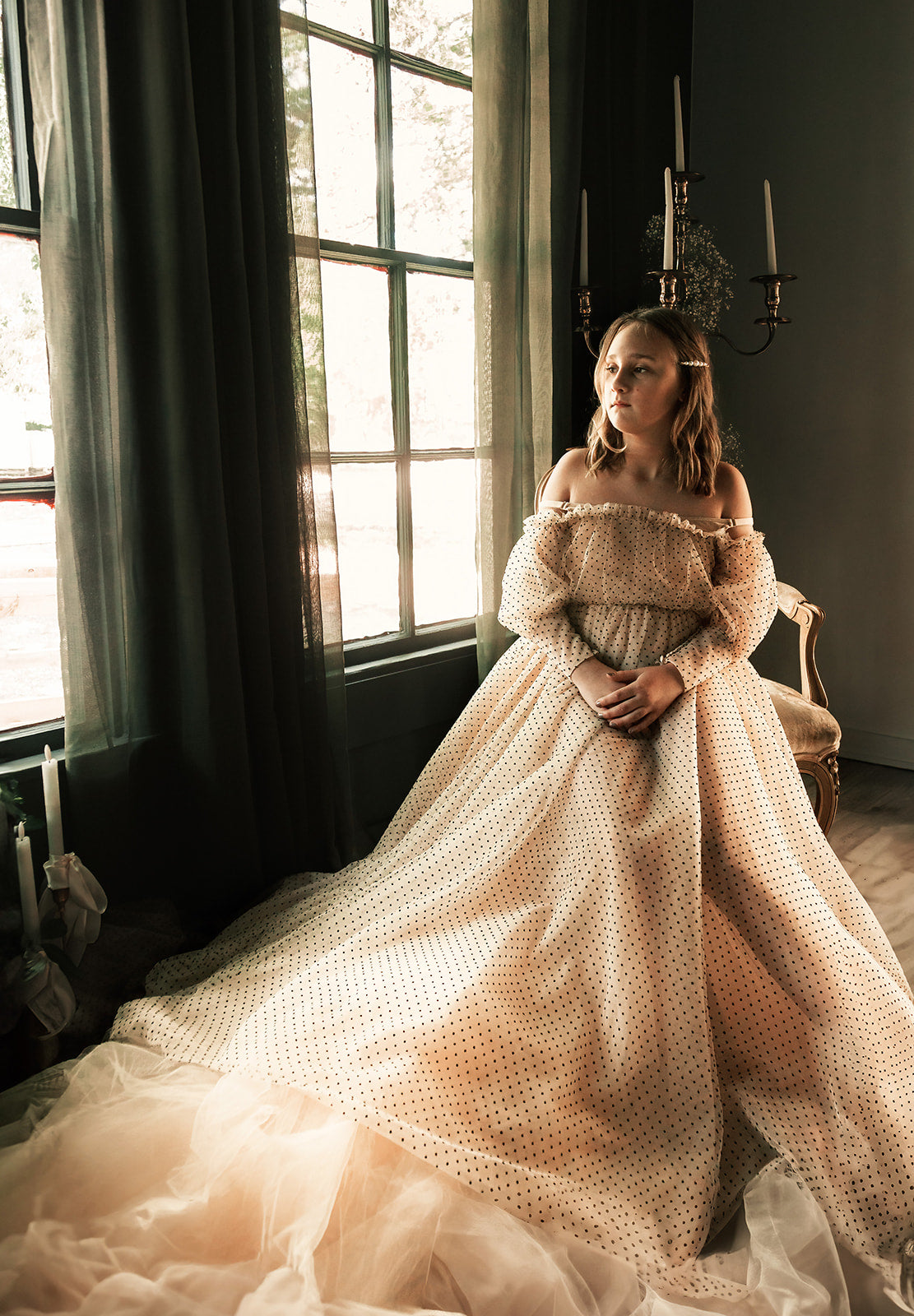 young girl posing in a couture swiss dot gown for family photography session.