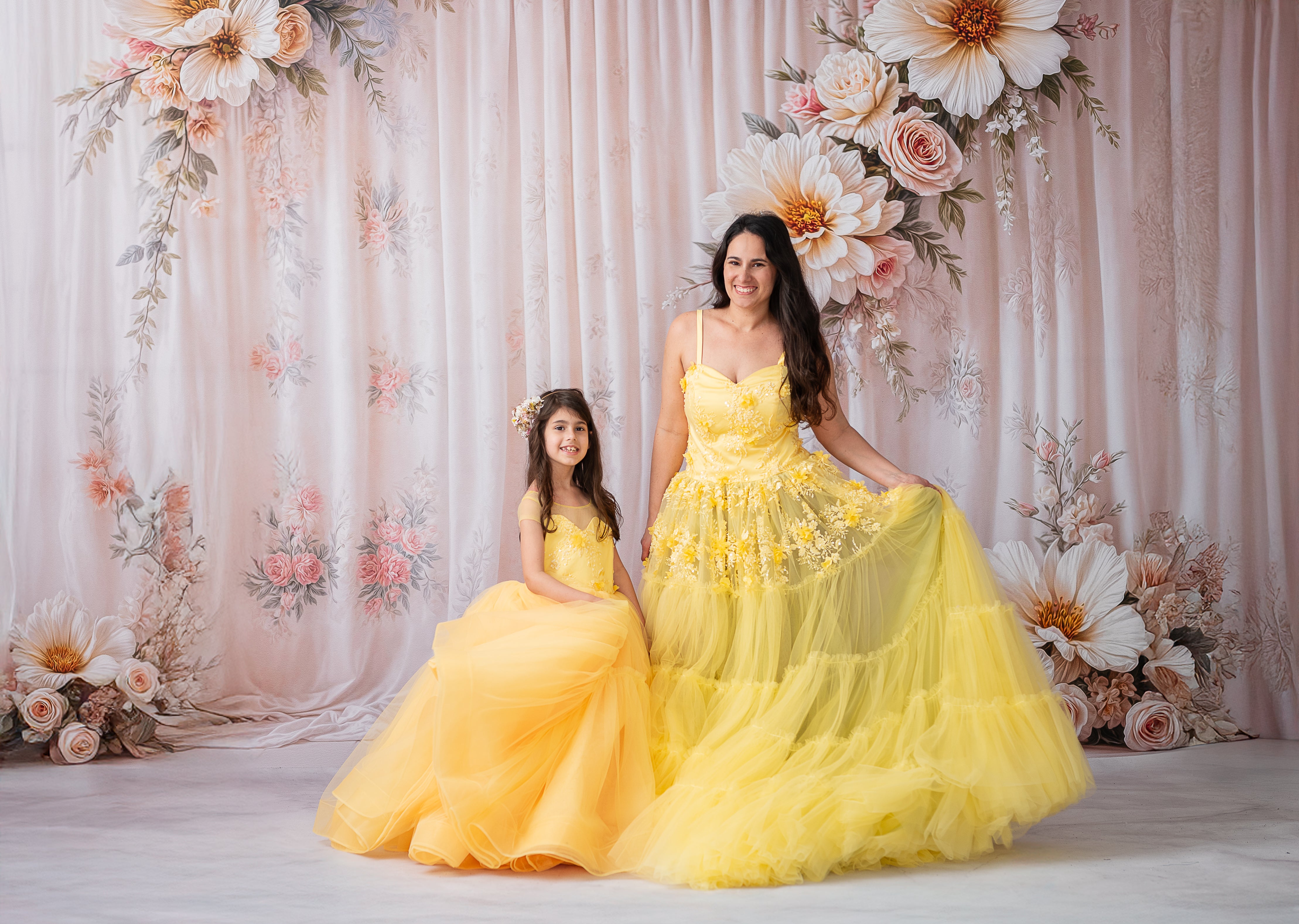 "Whimsical yellow Buttercup gown with layers of green and blush pink tulle beneath the skirt."