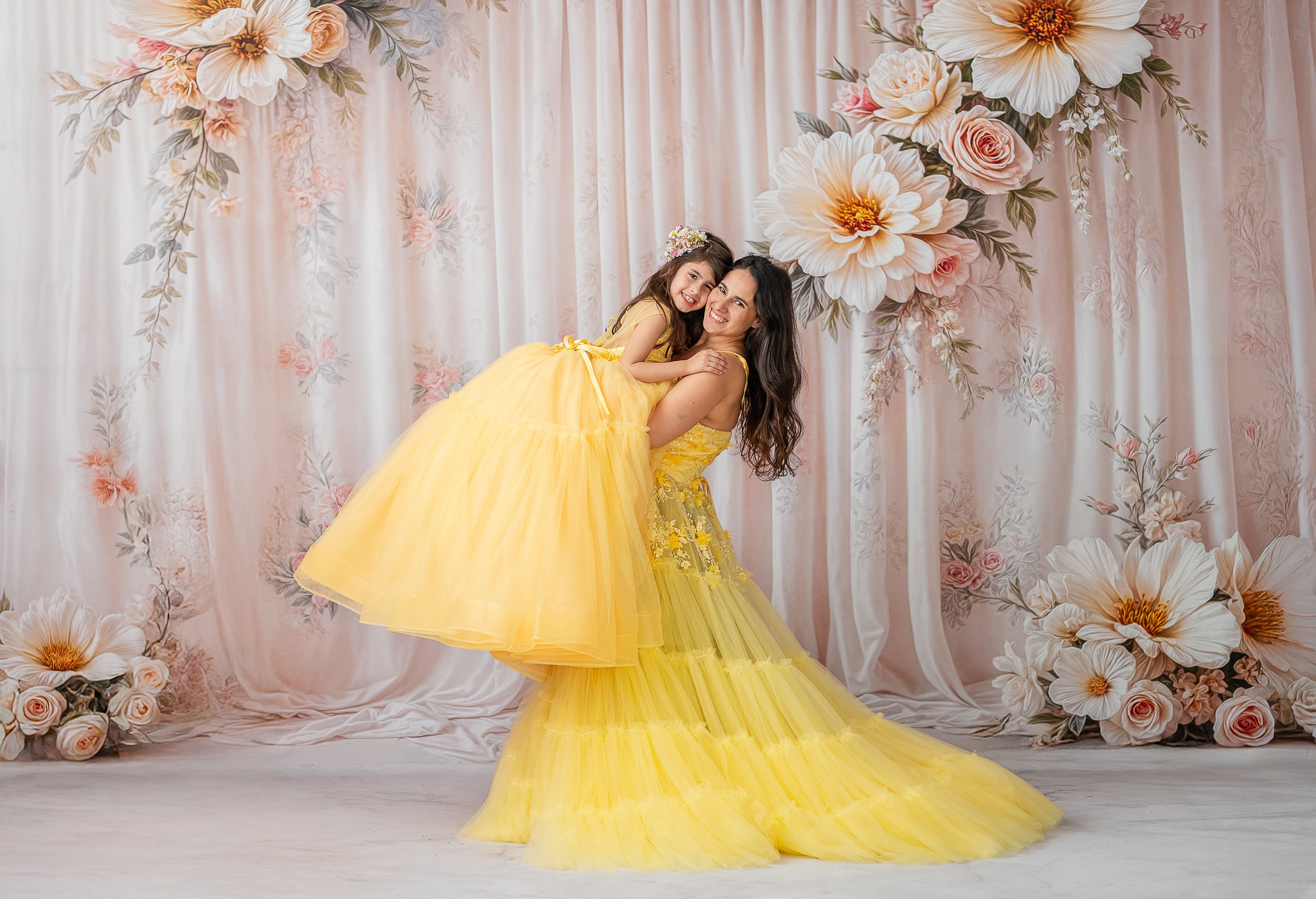 "Buttercup gown featuring delicate 3D floral appliqués on a structured bodice."