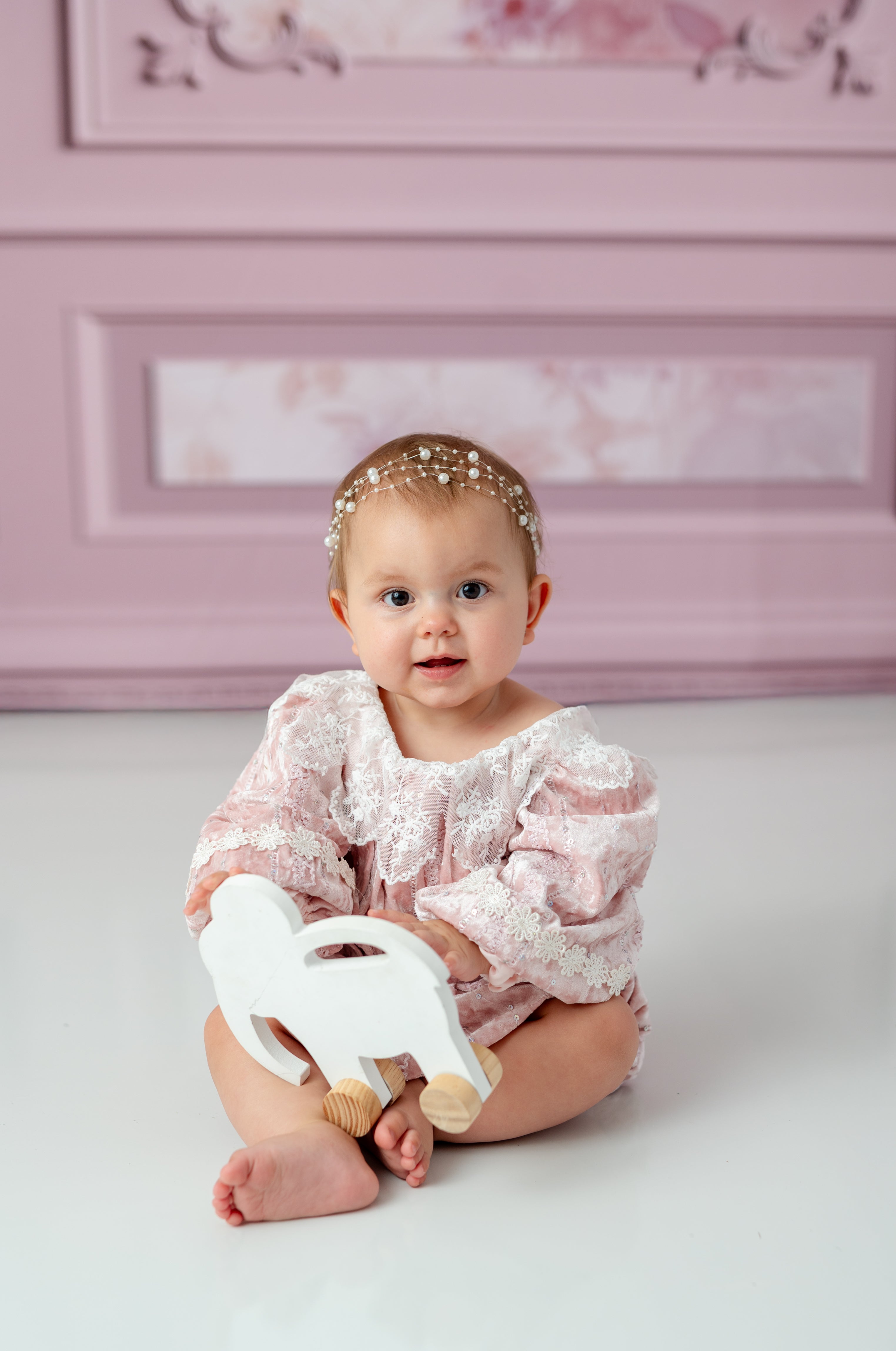 Side view of toddler in velvet and lace baby outfit
