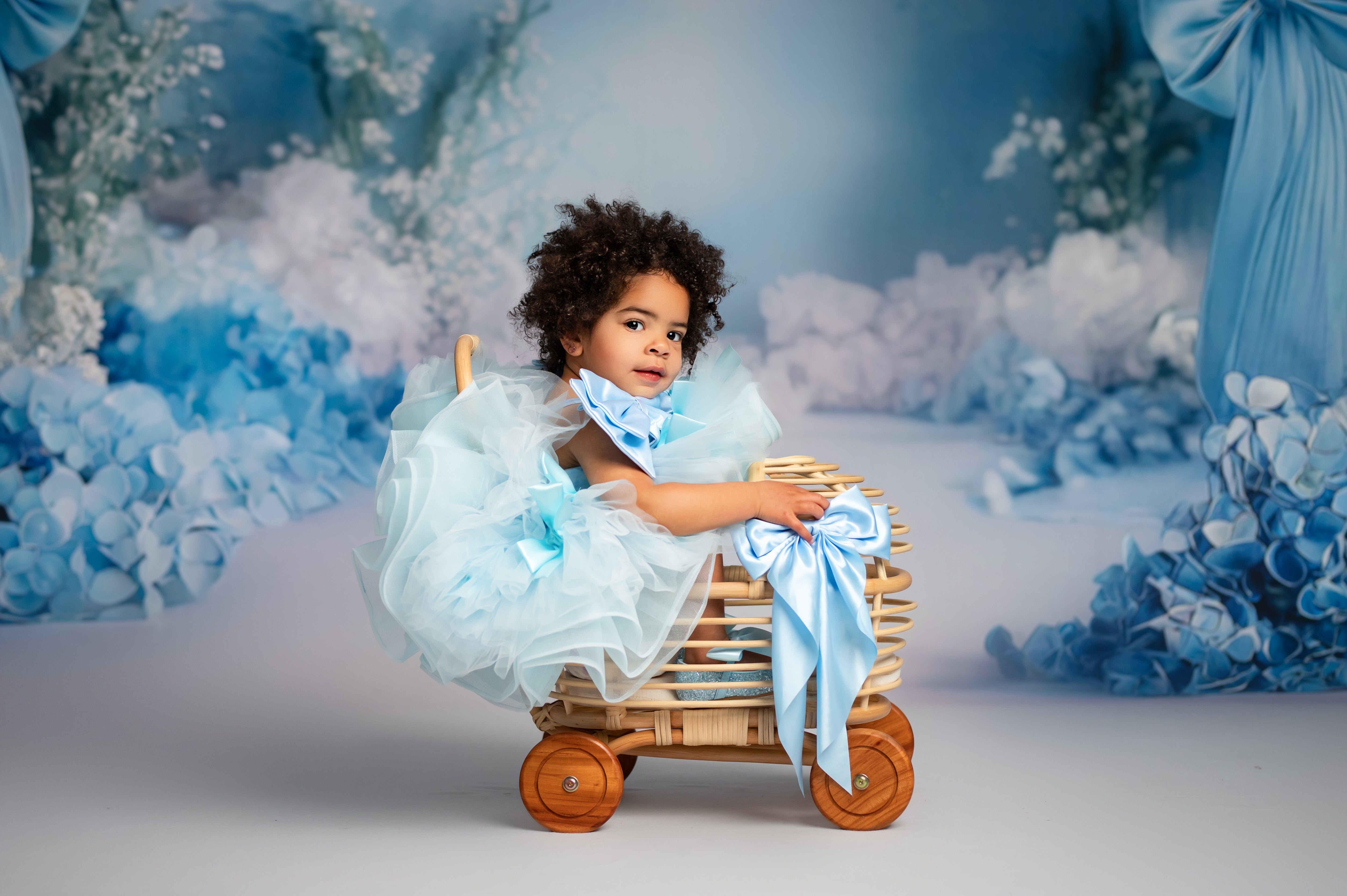 Whimsical soft tulle gown adorned with handmade satin bows.