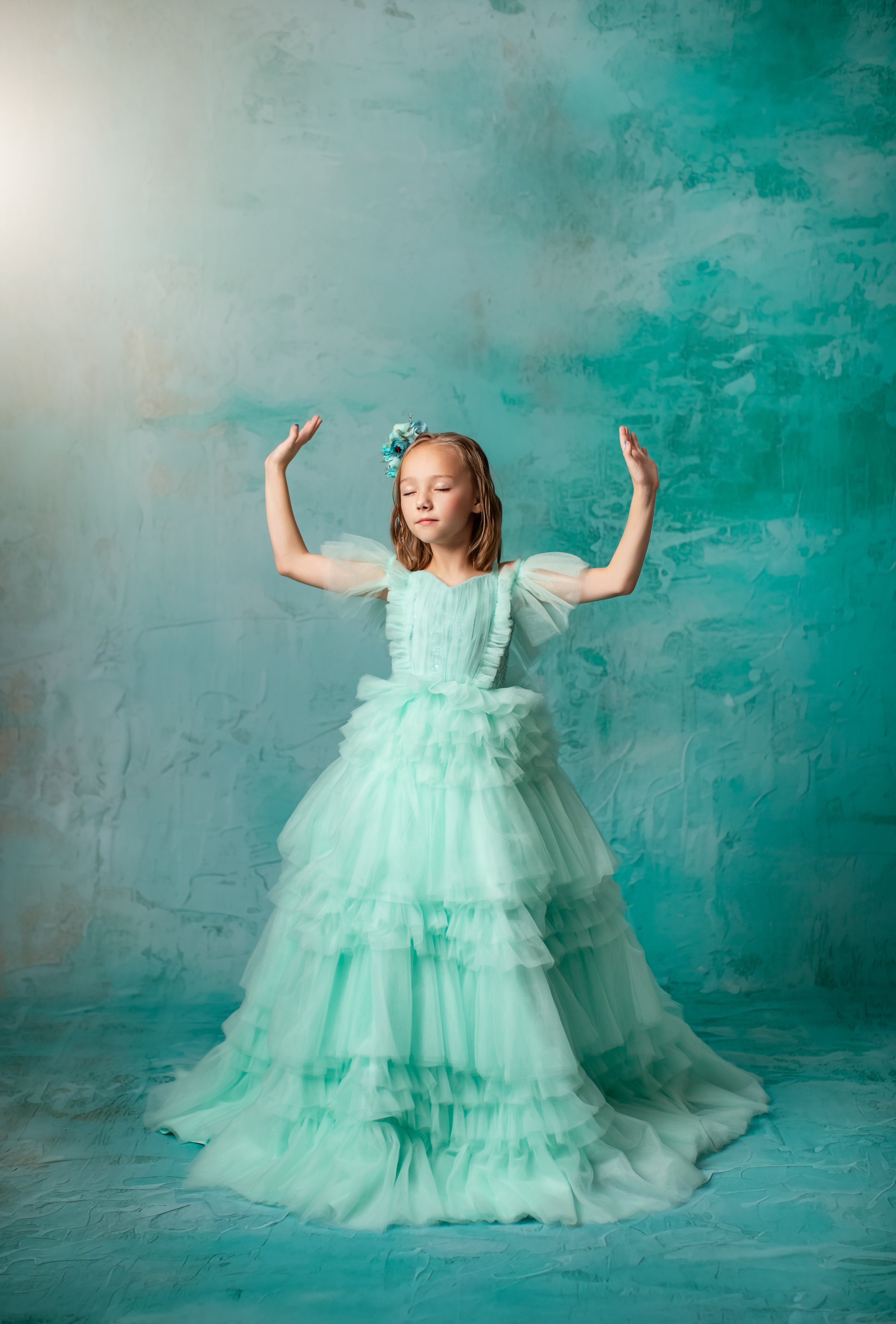 "Mint green gown with ruffled details and delicate off-shoulder sleeves."