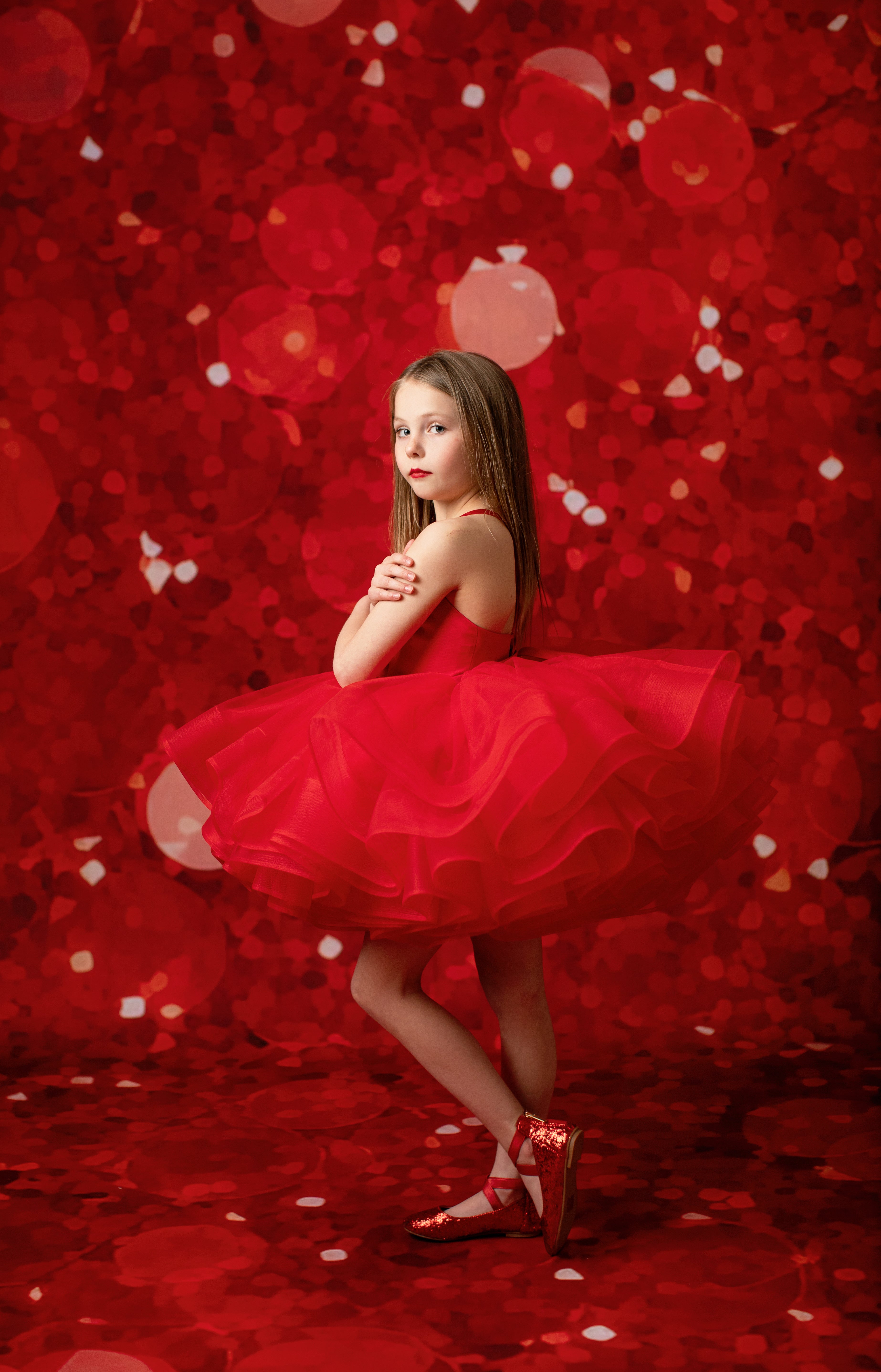 Classic custom red gown designed with luxurious fabric for a timeless look.