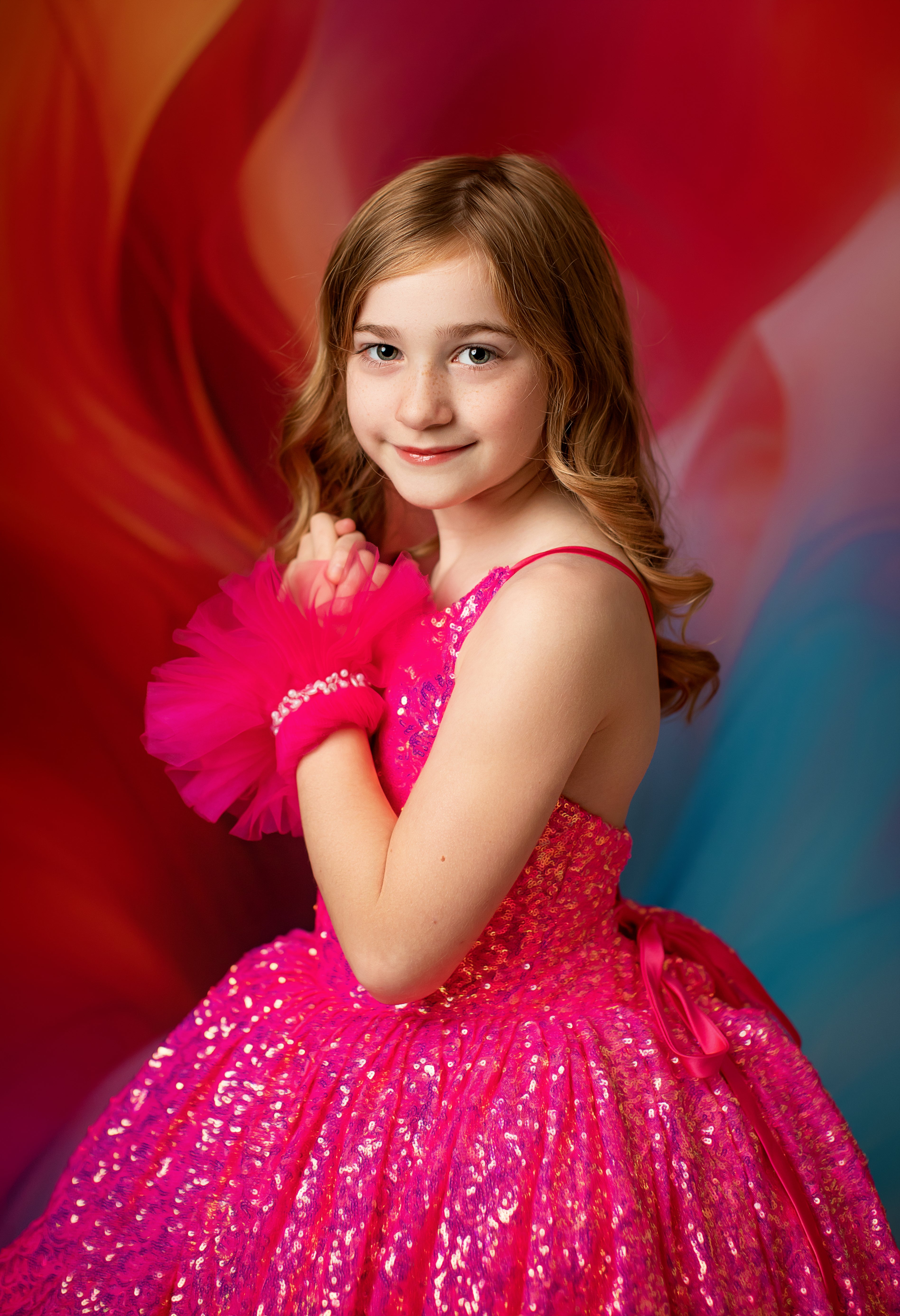 Young girl posing in a high-low silhouette Sparkling Princess gown.