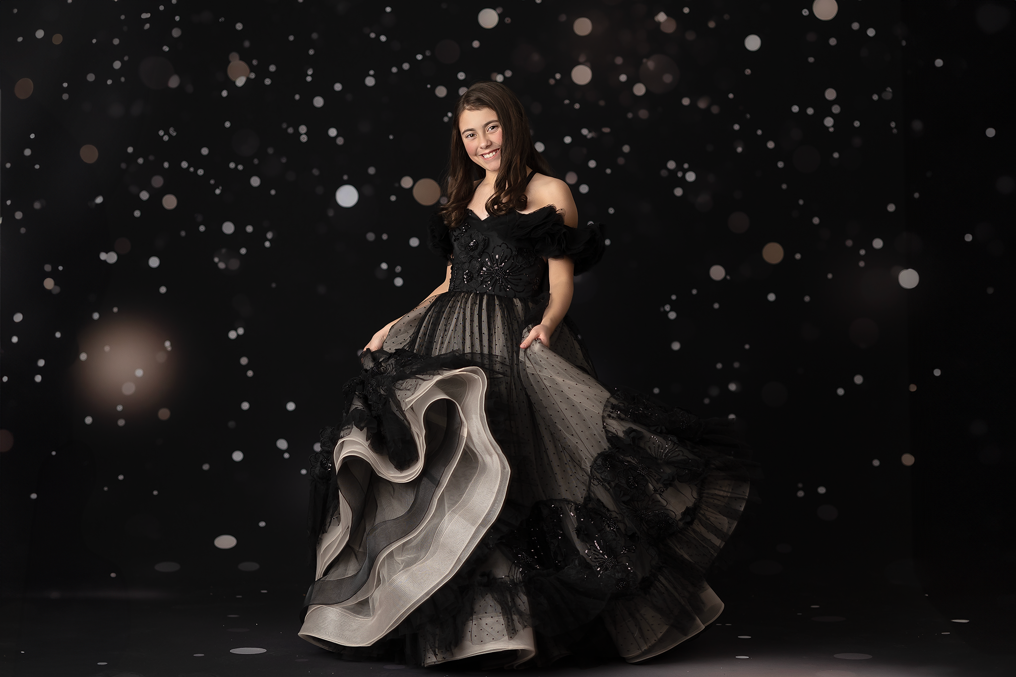 Elegant black gown with lace bodice and layered skirt, designed for photography sessions and formal events.