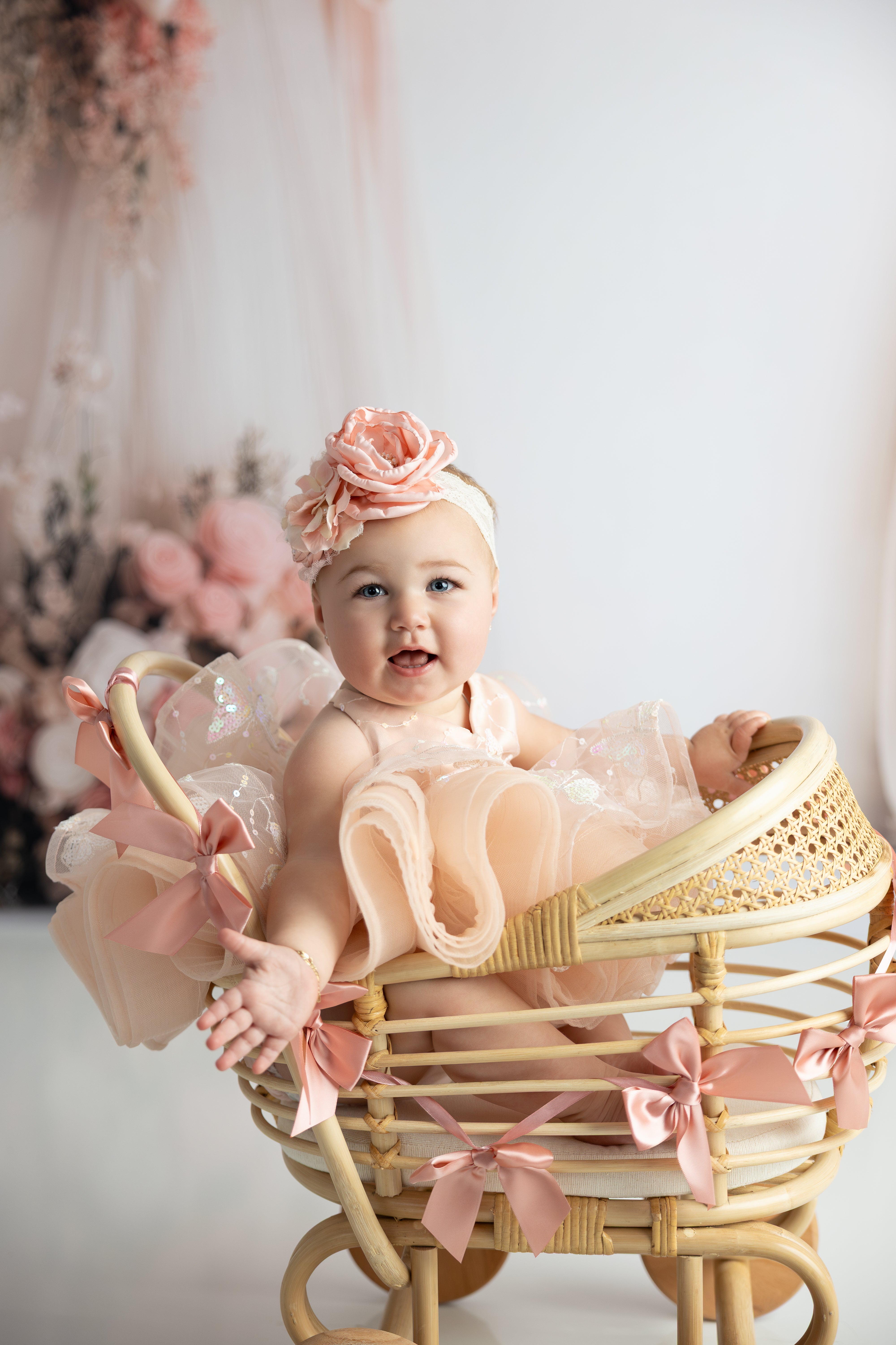 "A sweet baby girl in the Vera petal dress, twirling with joy in a sunlit room."