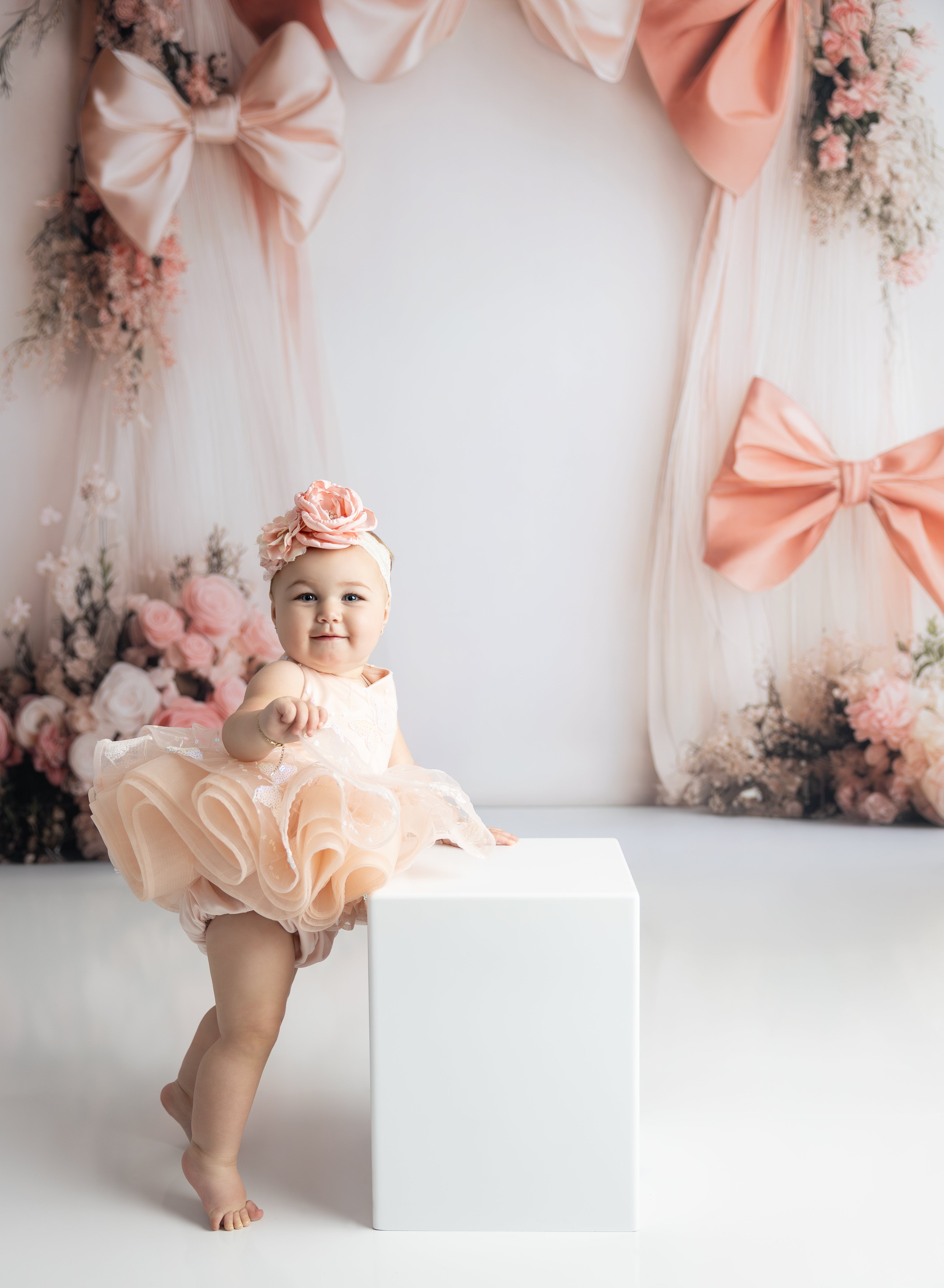 Soft pink Vera petal dress with delicate floral details and matching bloomers, perfect for milestone photos.
