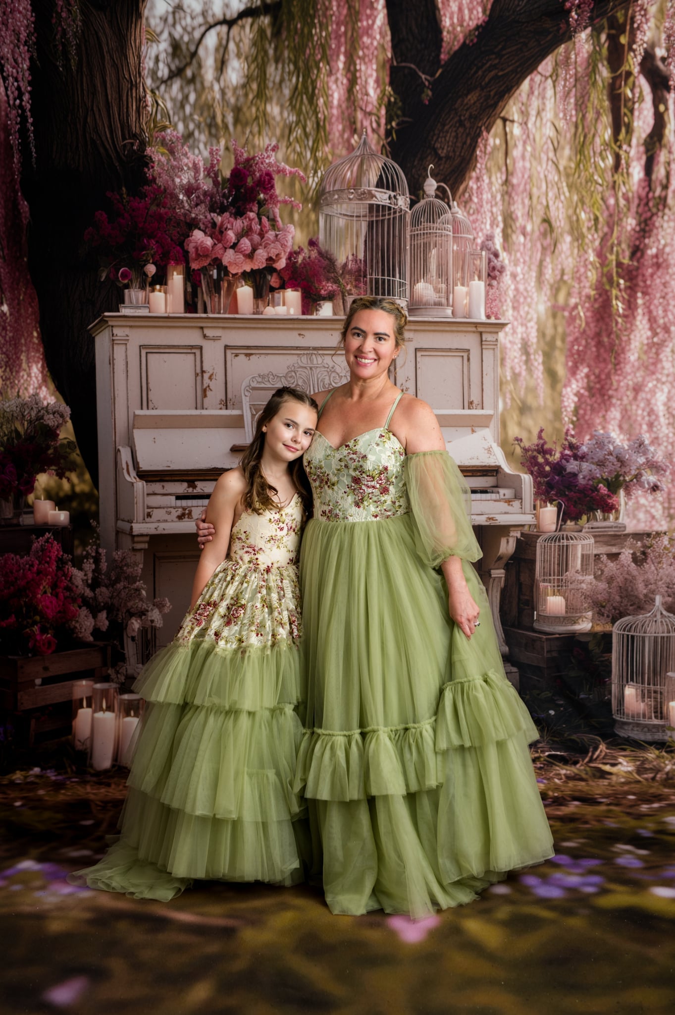 Two women in elegant dresses standing in a decorative setting with flowers and a piano.