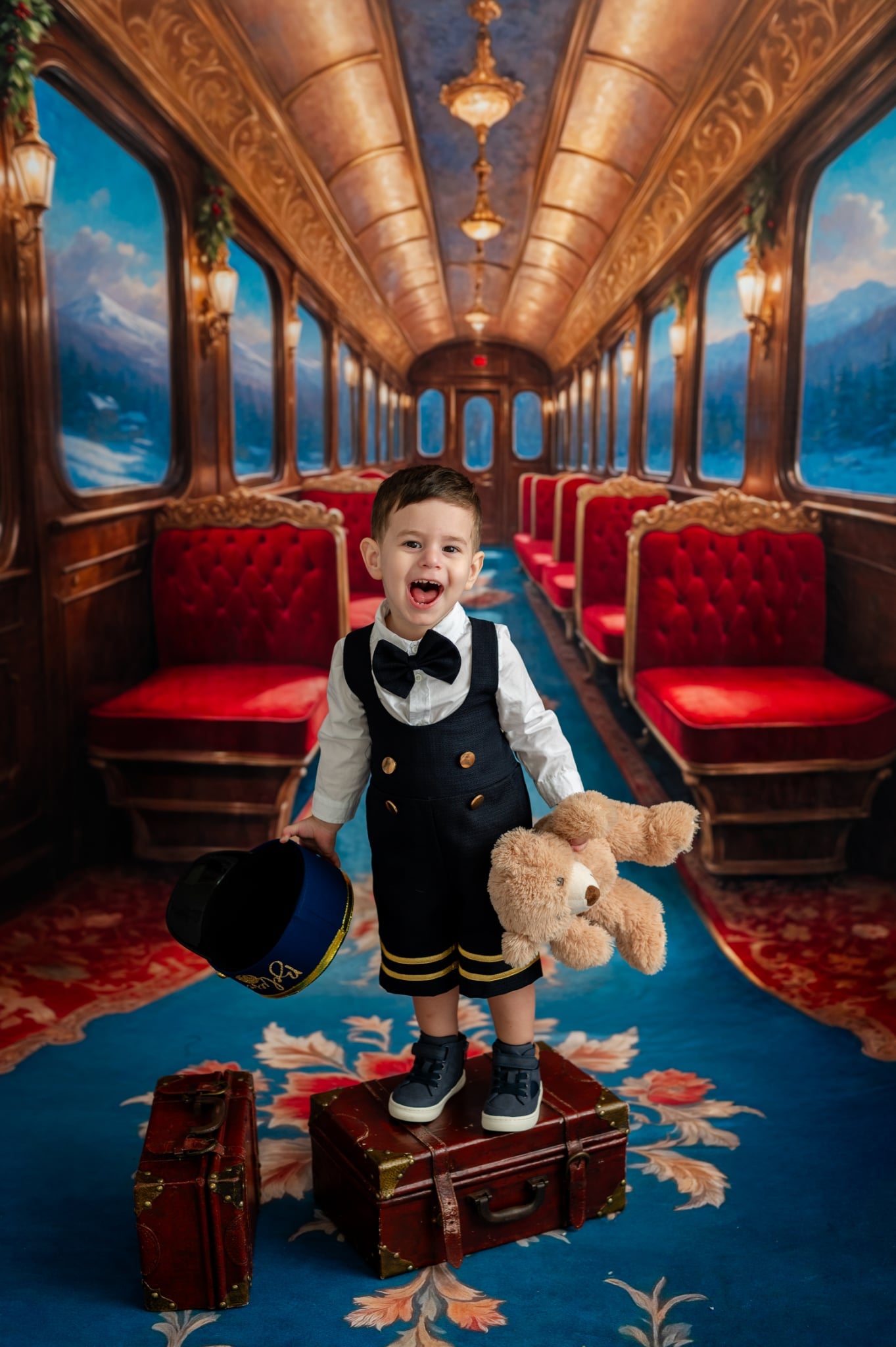 Child in a vintage train car with red seats and ornate ceiling, holding a teddy bear.