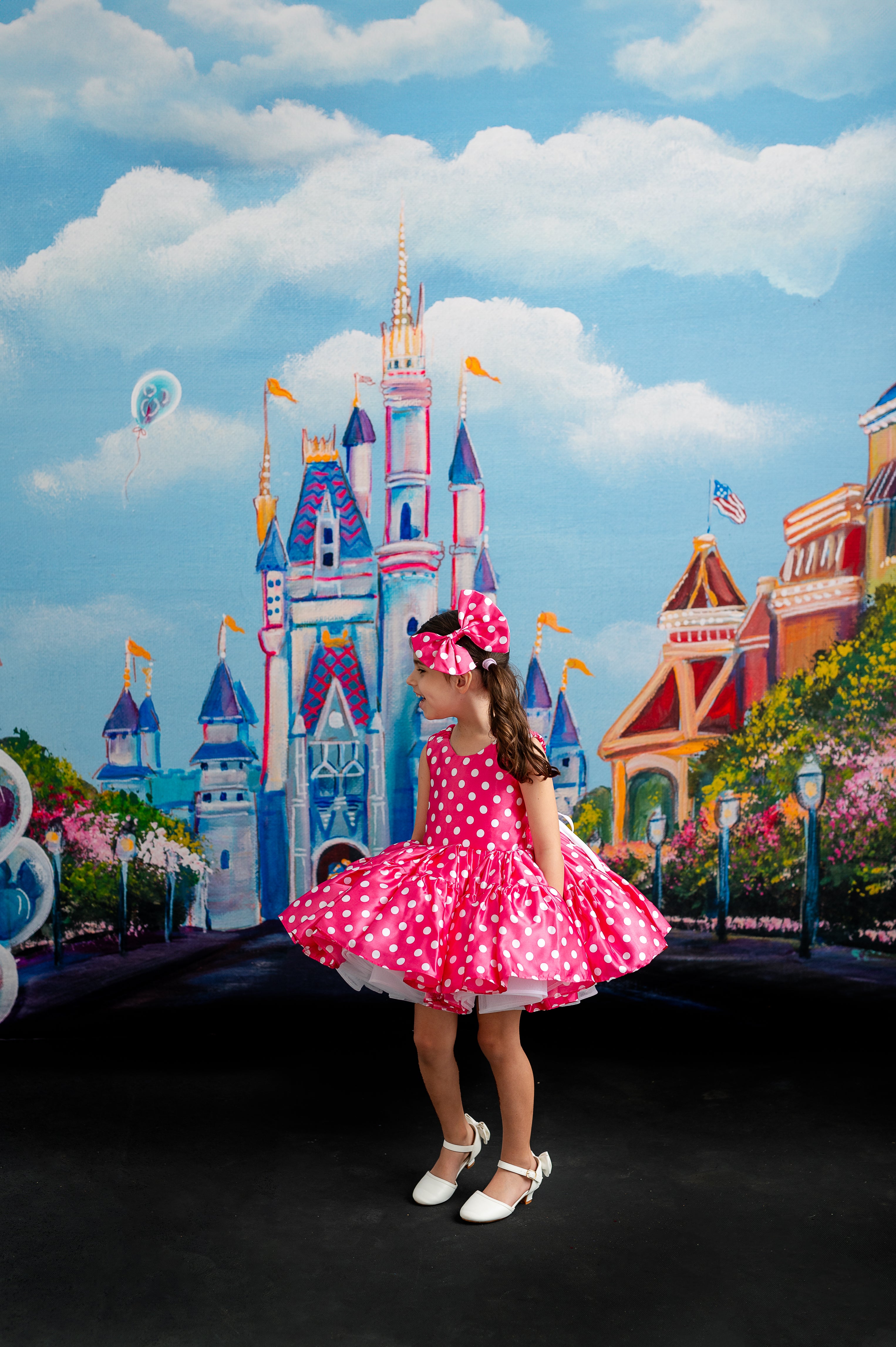 "Whimsical pink and white polka dot Minnie dress featuring a sweetheart neckline, elegant bow accents, and a fun, flowing skirt."