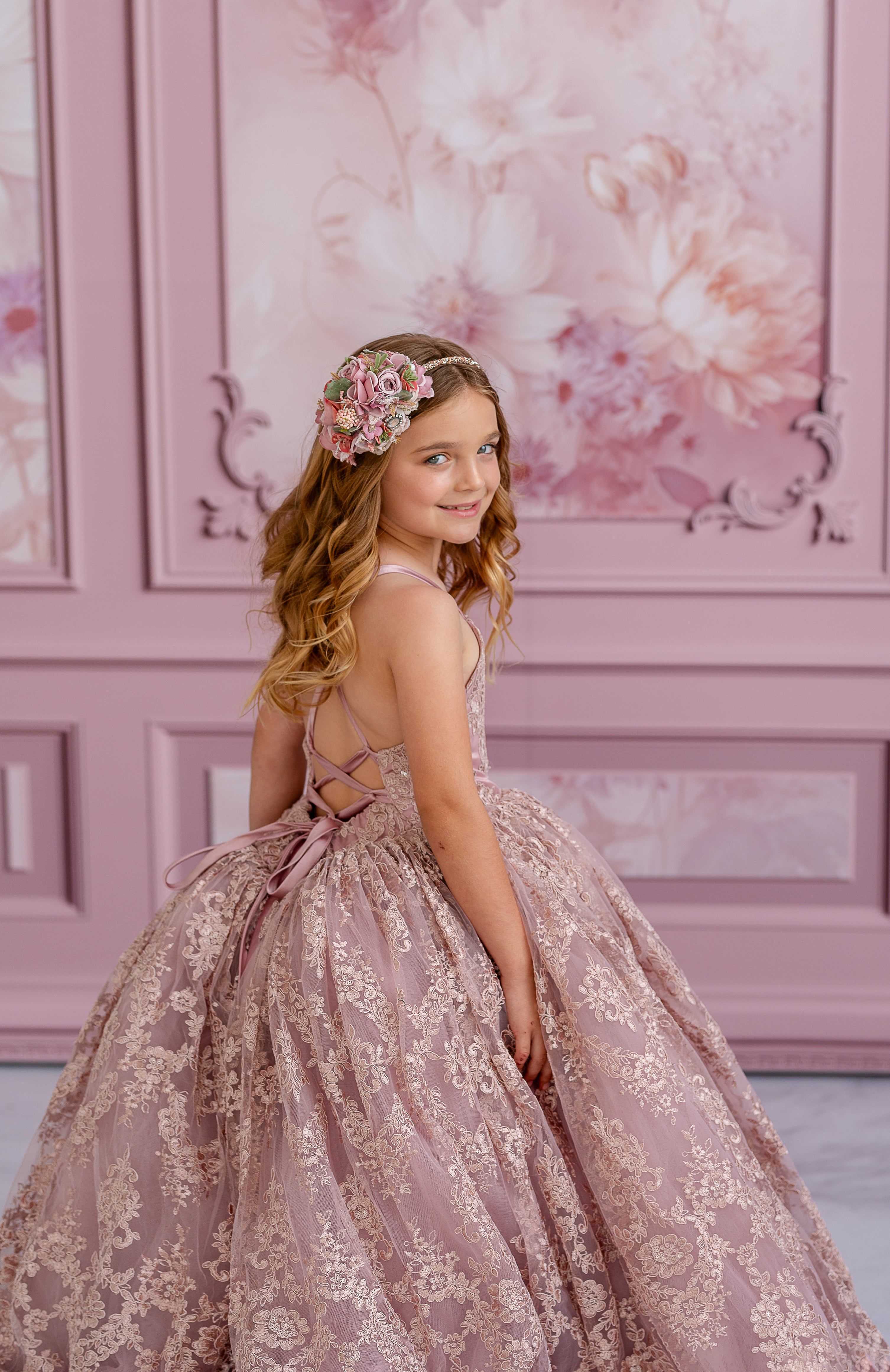 "Front view of a timeless couture gown featuring shimmering lace accents and a floor-length silhouette"